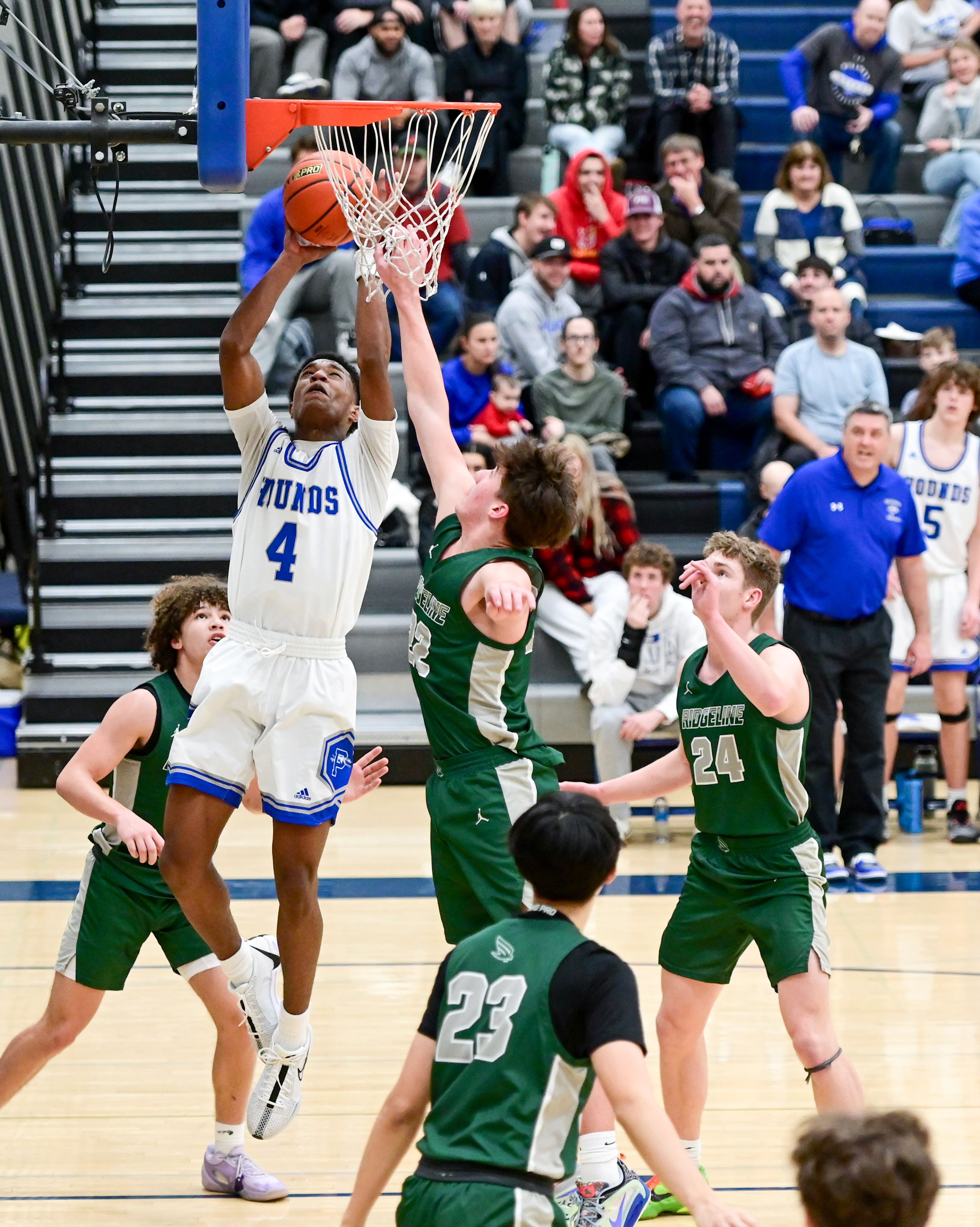 Pullman senior Champ Powaukee (4) jumps for a two-point shot at the net during a game against Ridgeline in Pullman on Tuesday.