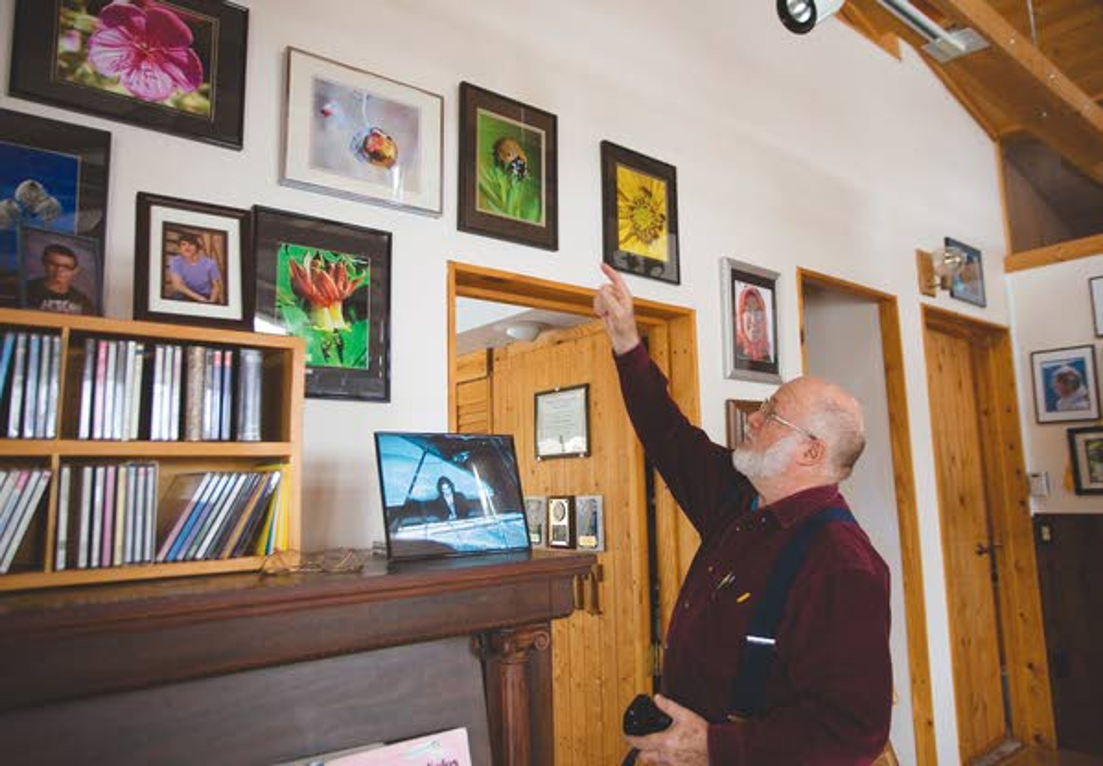 Gerry Queener talks Friday about his photograph of a ladybug that was as big as his index finger fingernail at his home in Troy.