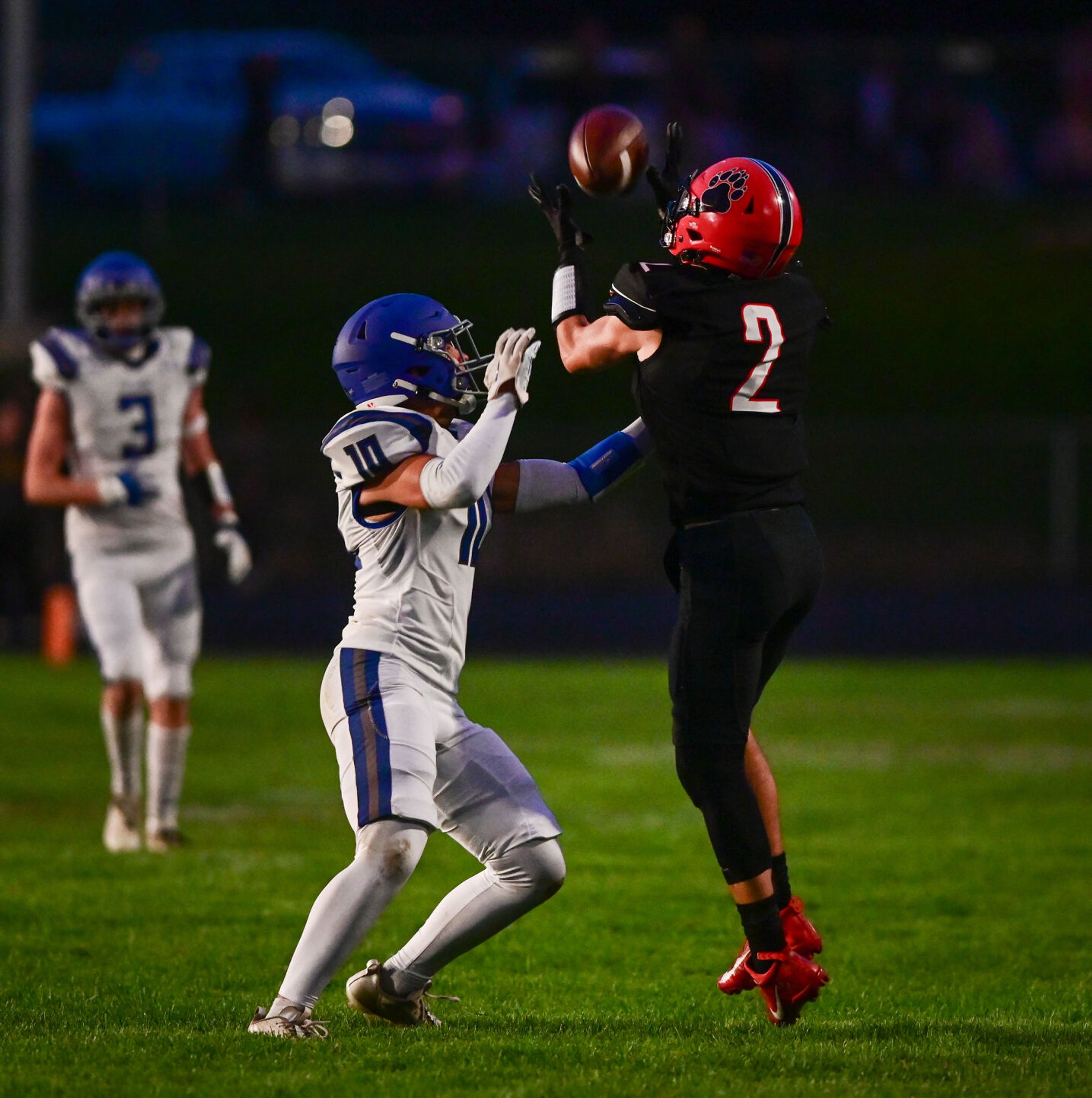 Moscow wide receiver Butch Kiblen completes a pass with pressure from Pullman defensive back Caleb Ratliff Friday in Moscow.