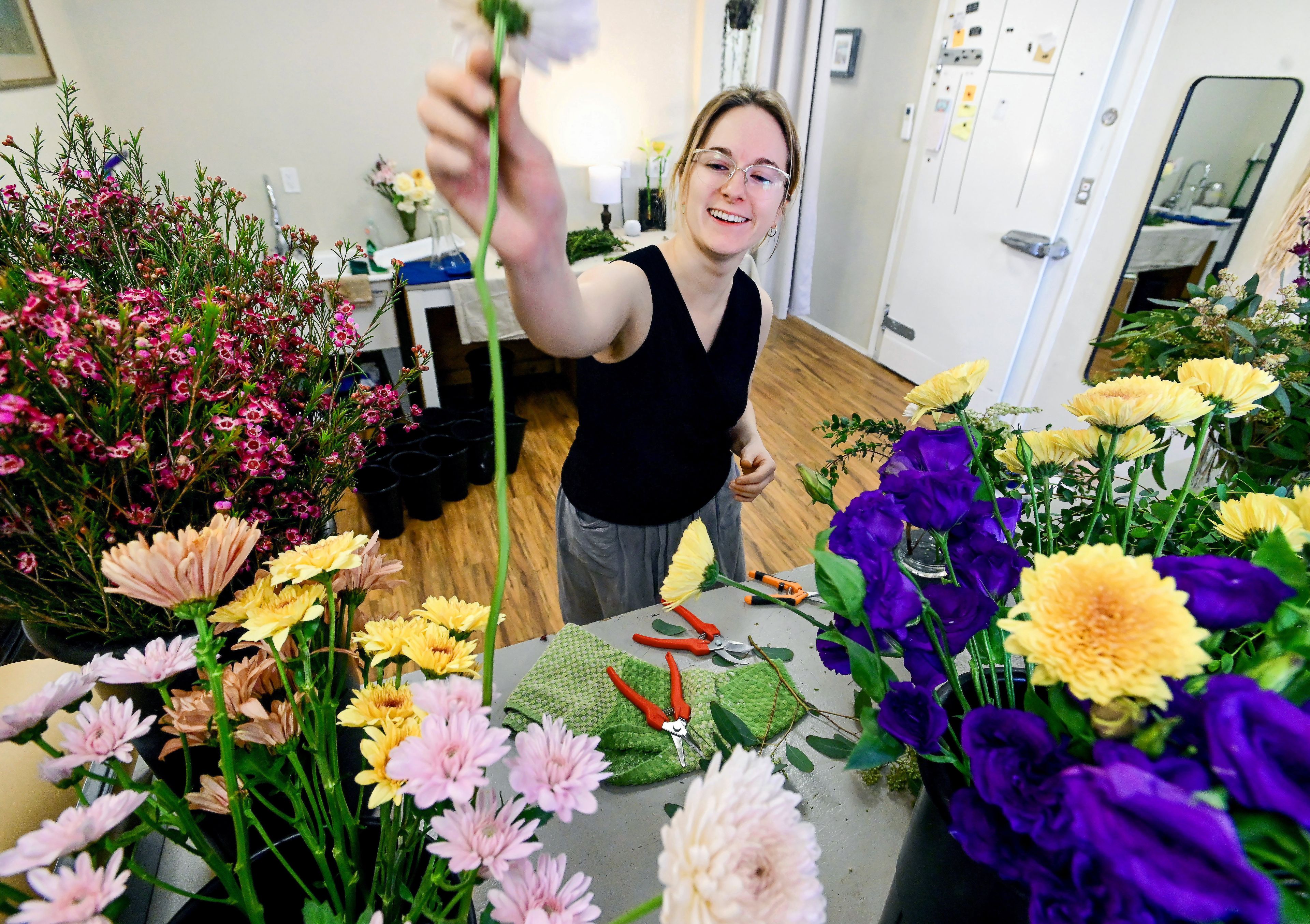 Co-owner of Garden and Villa Sarah Tucker pulls a flower for an arrangement at the florist shop’s new permanent location in Moscow on Thursday. Gardena and Villa took over the space from Little Shop of Florals at the start of the year and celebrated a grand opening in February after three years of operating out of their apartment.