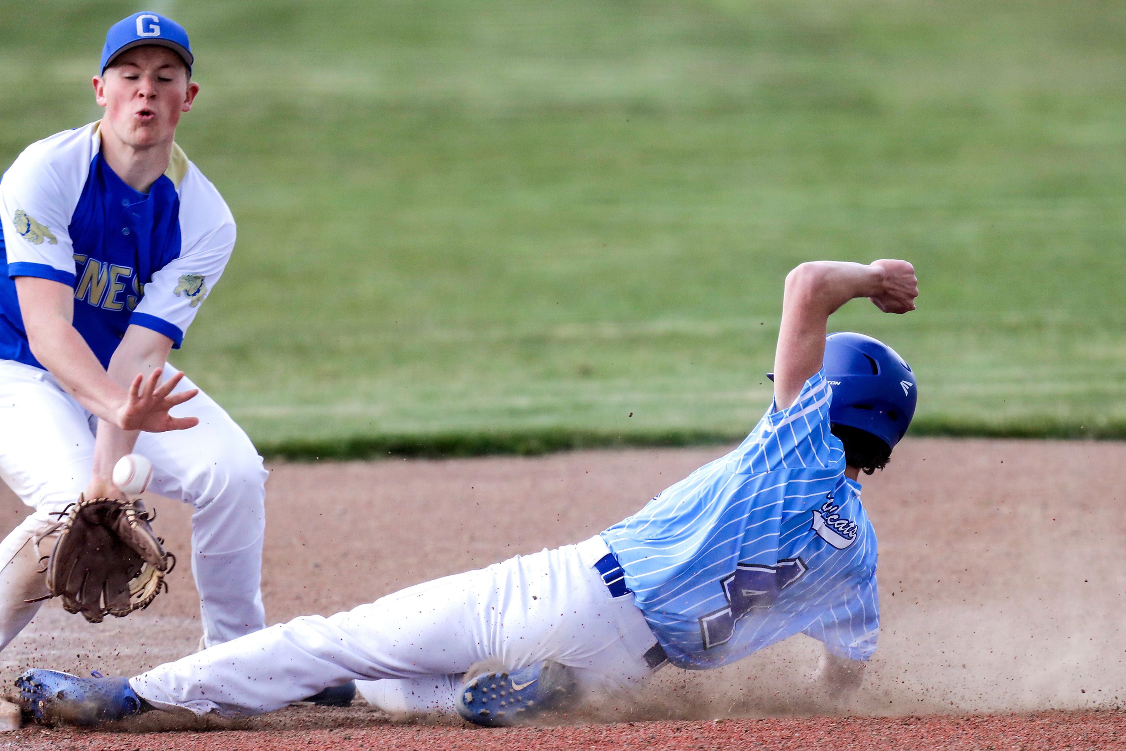 Colton Angus Jordan slides into third base as Genesee third baseman Cole Riebold attempts to catch the ball in Genesee on Monday.