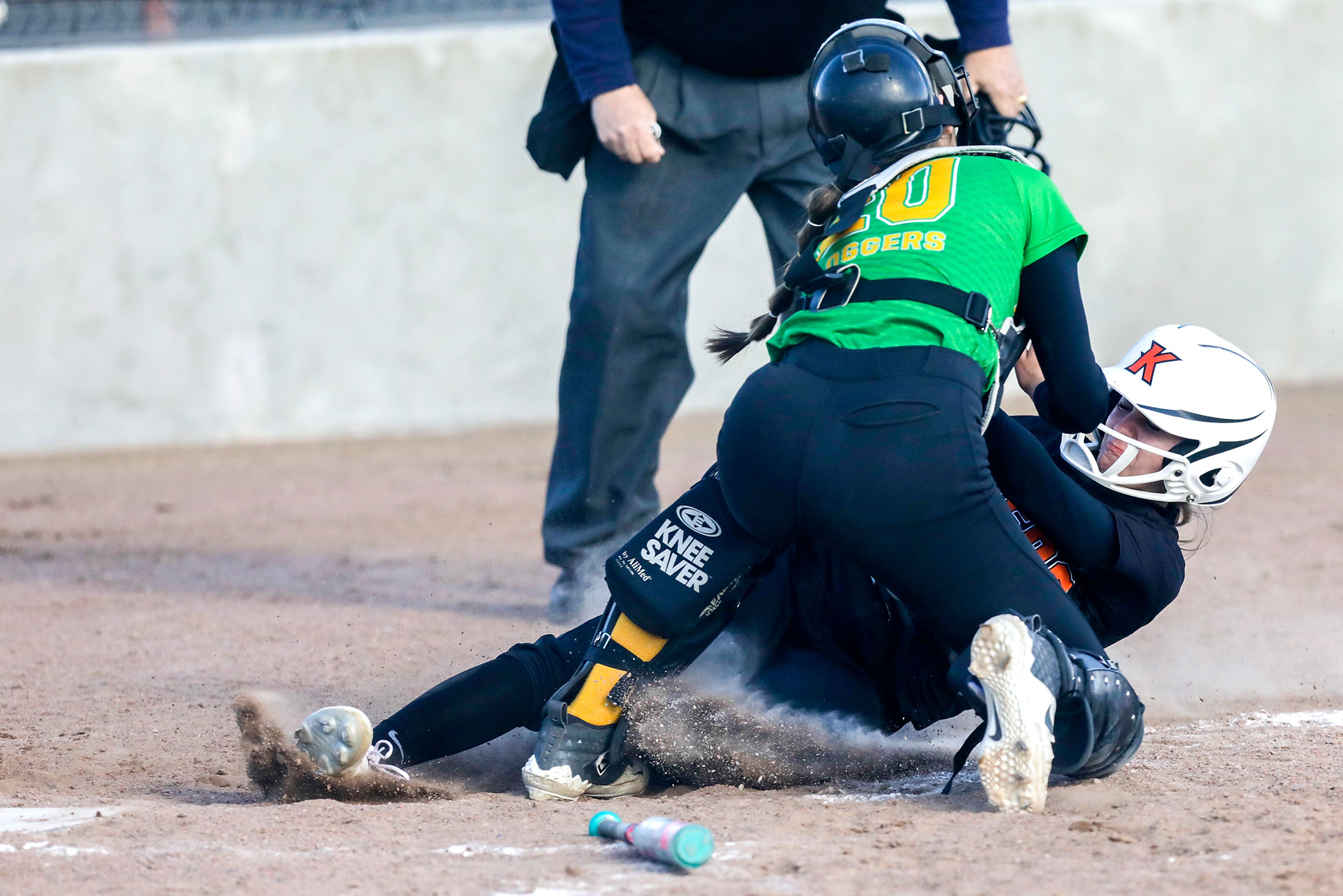 A Kendrick High baserunner is tagged out by the Potlatch catcher as she slides into home. Potlatch defeated Kendrick 12-11 in the Class 1A district final in Genesee on Wednesday.