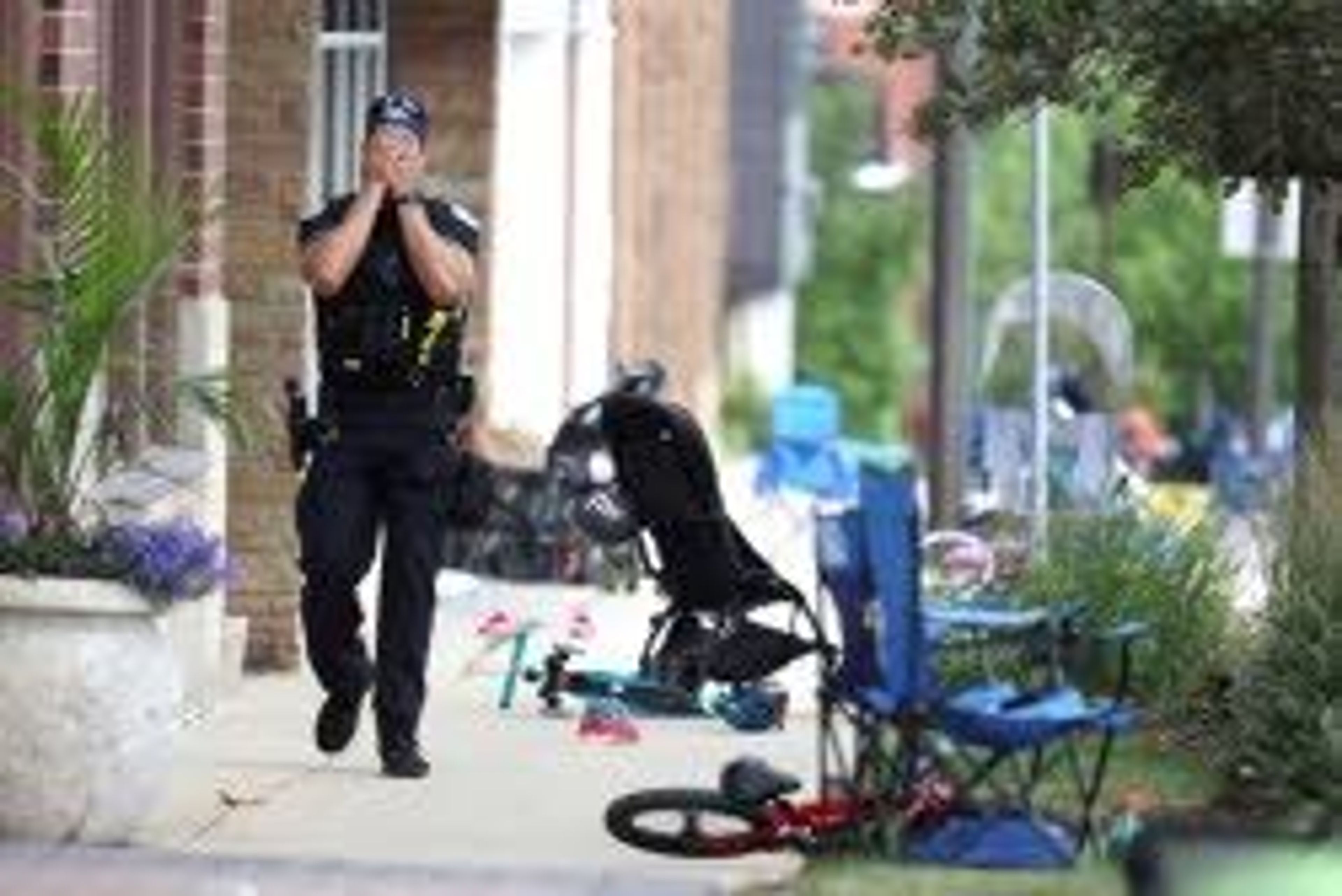 Associated Press A Lake Forest, Ill., police officer walks down Central Ave in Highland Park, Ill., on Monday after a shooter fired on the northern suburb’s Fourth of July parade. Six people were killed and at least 30 others were wounded in the attack.