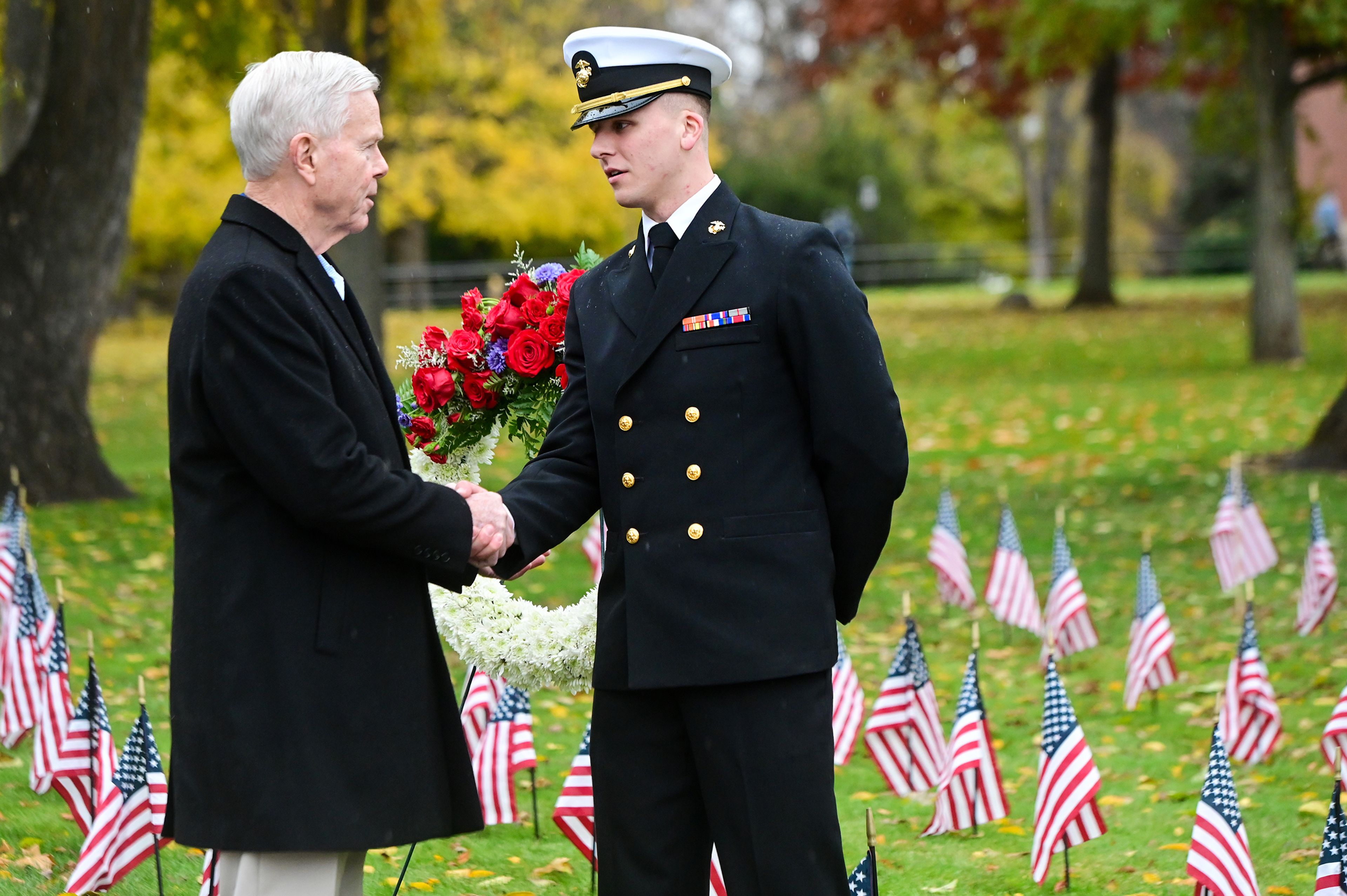 Gen. James F. Amos, left, shakes hands with Cody Dotson, right, a midshipmen in the University of Idaho’s ROTC program, after the two laid a wreath at the UI Veterans Day ceremony Monday in Moscow.