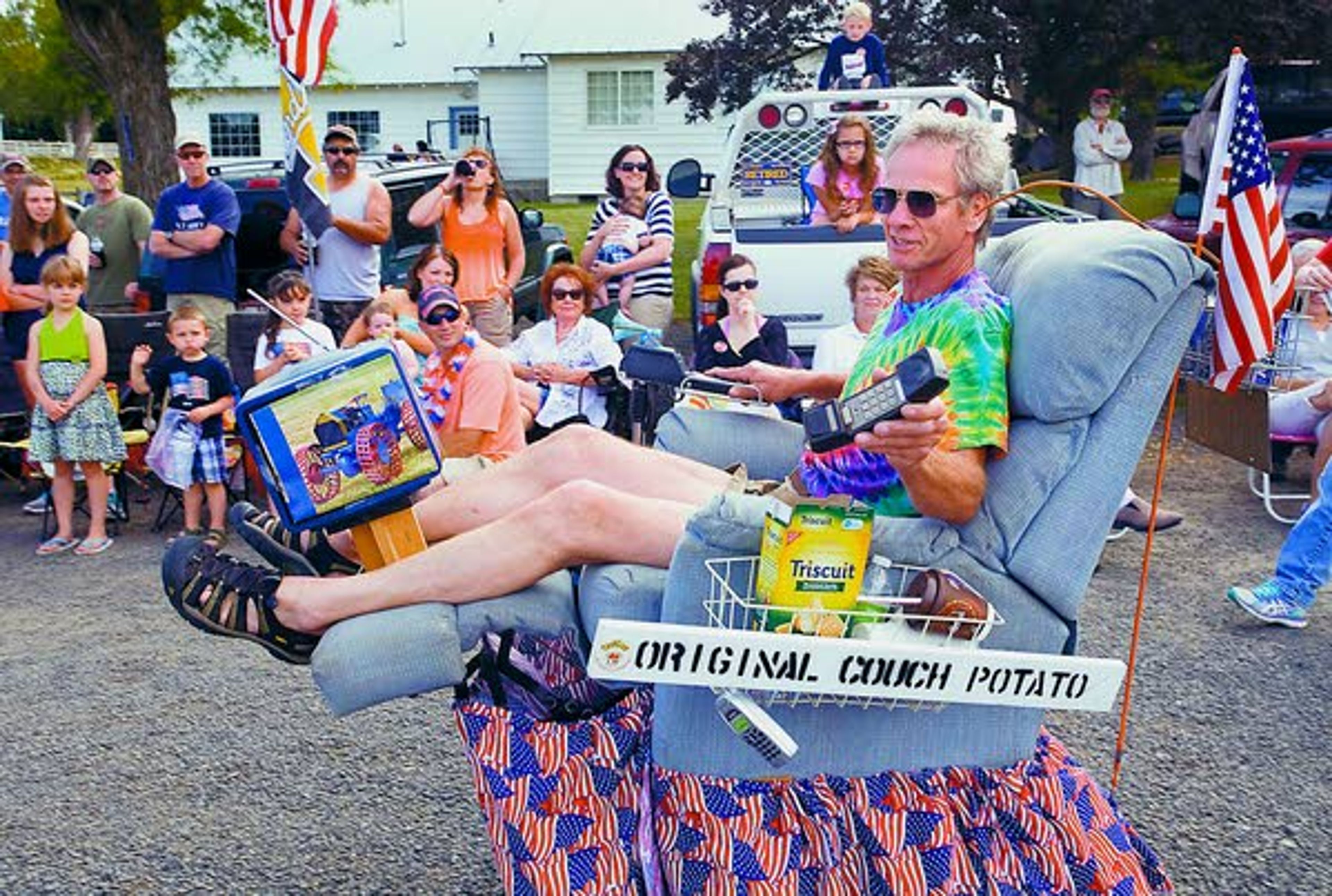 Tim Reisenauer of Kennewick, Wash., plays the role of the original couch potato Saturday during the Johnson Independence Day Parade.