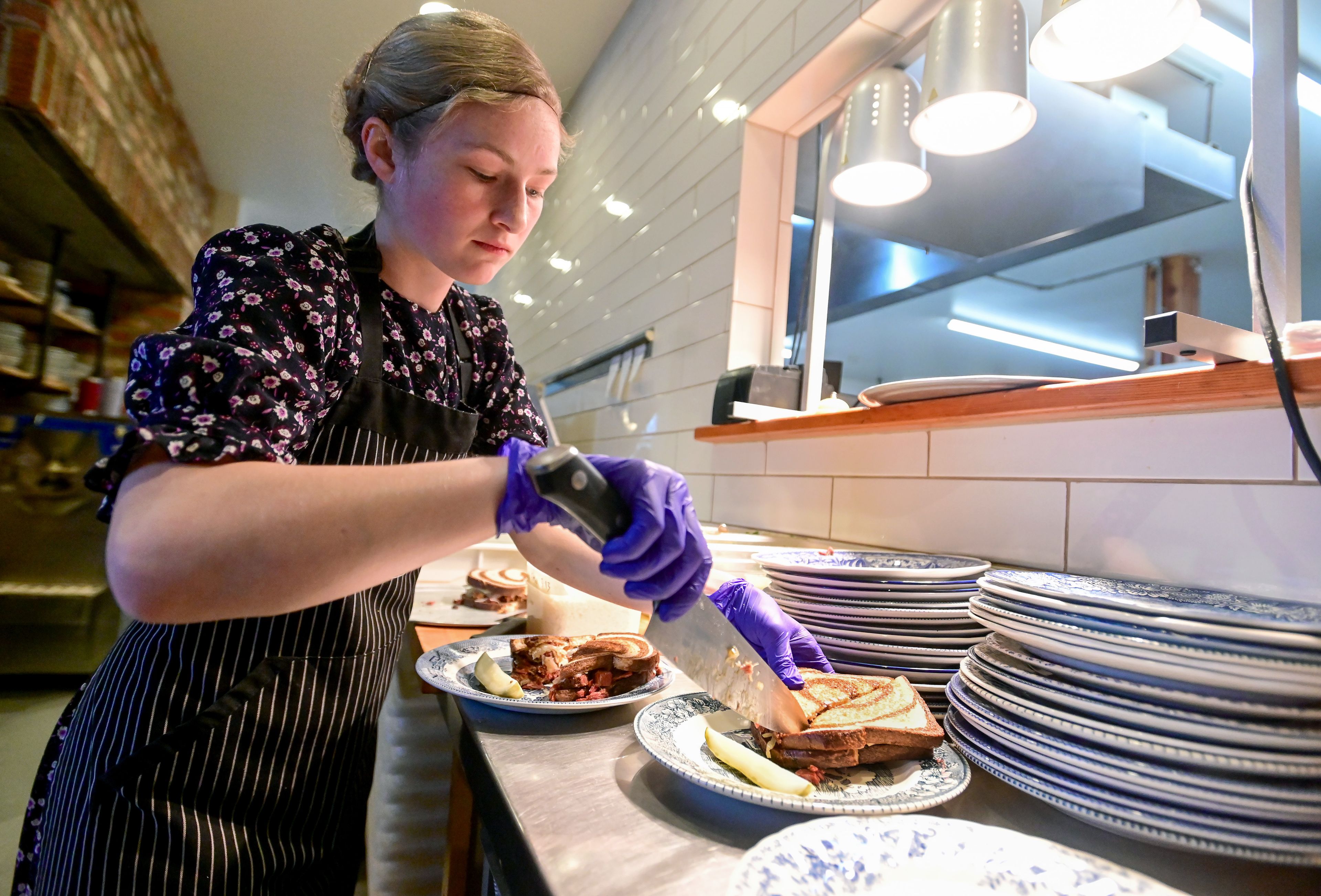 Pie maker Rilla Wincentsen, 20, plates rueben sandwiches at The Pie Safe Bakery in Deary on Wednesday.