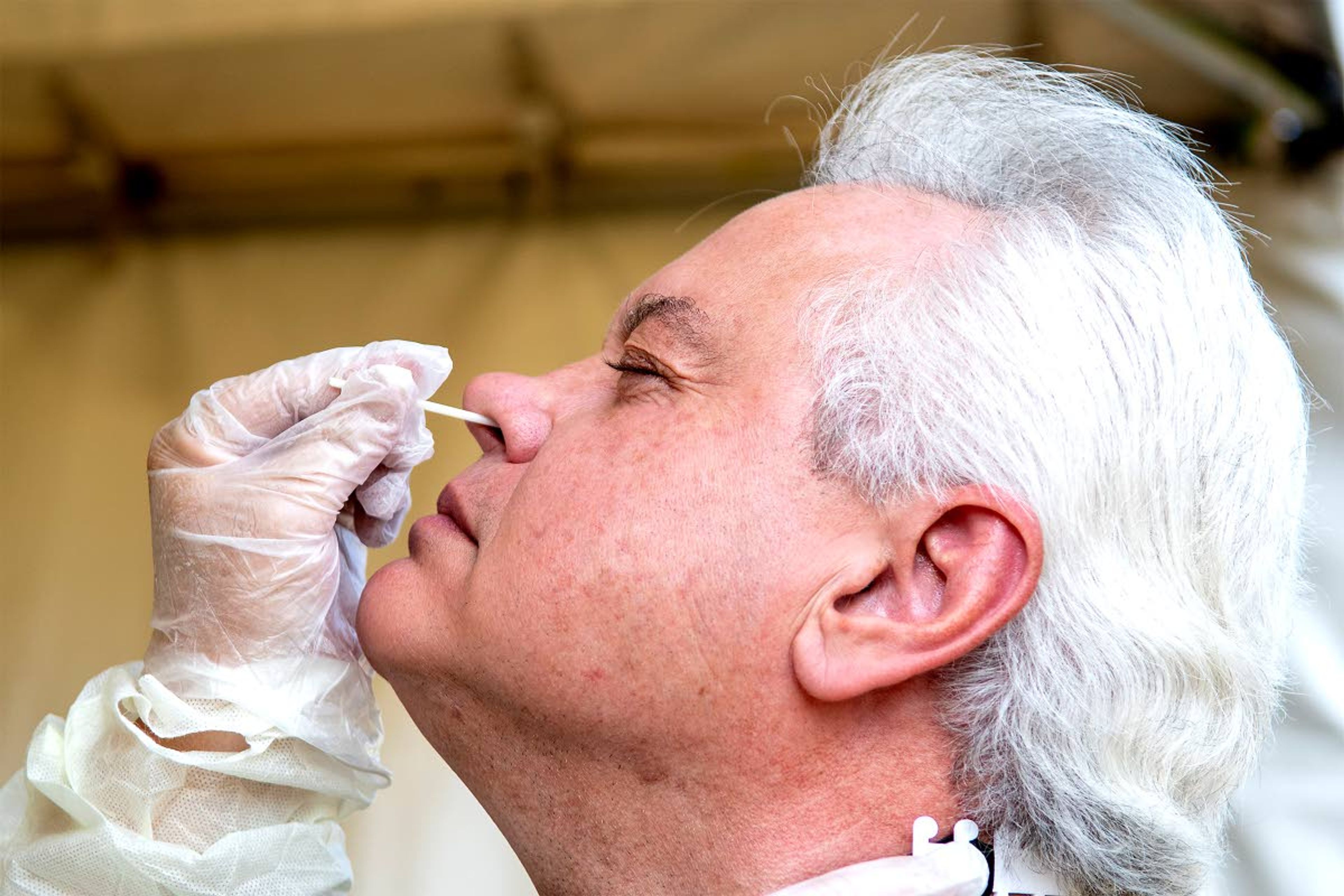 August Frank/Lewiston TribuneAlecia Hart pushes a swab into the nose of University of Idaho President Scott Green to test for COVID-19 on Wednesday during a test run of how the university will test students as they return to campus.