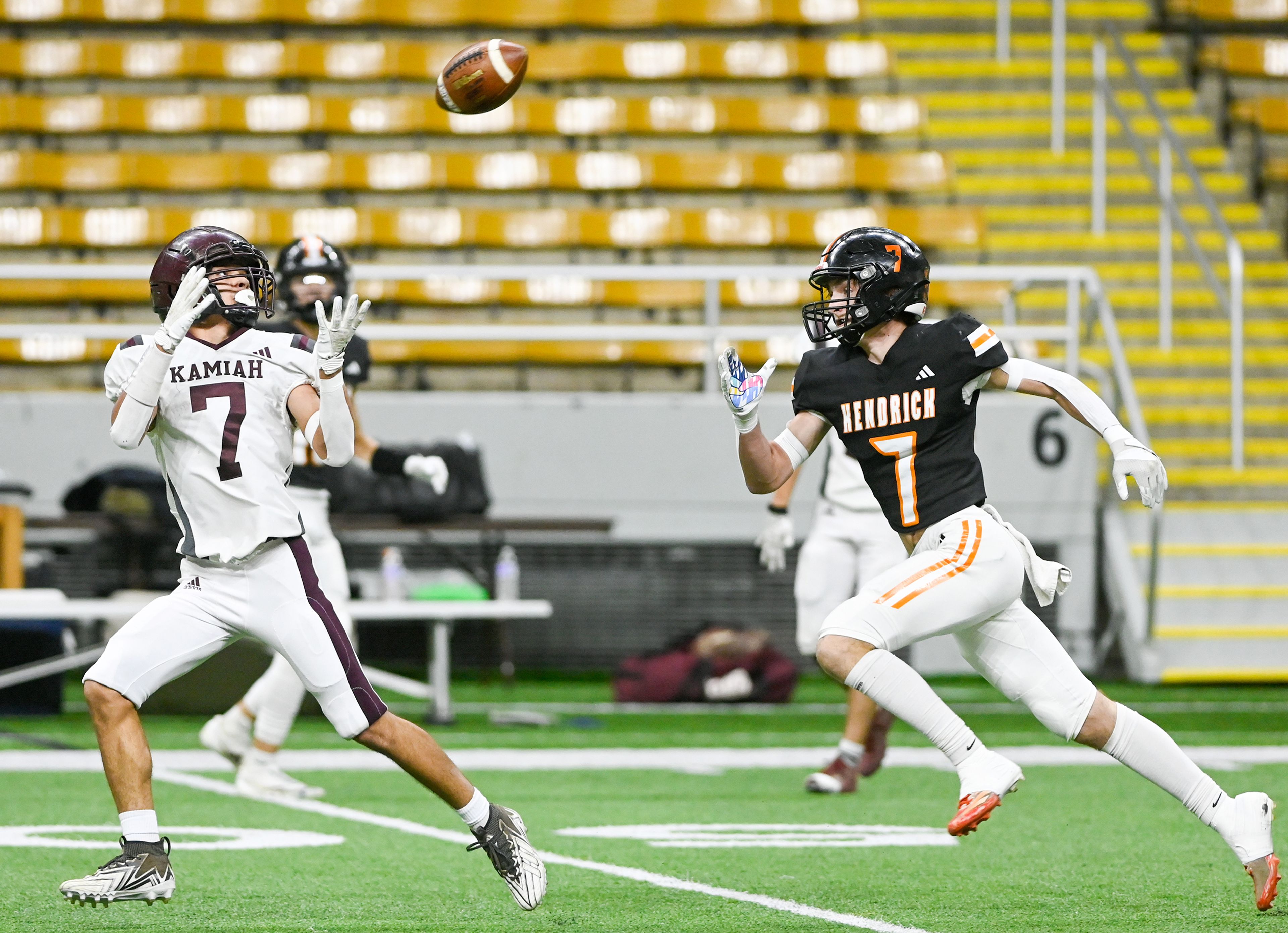 Kamiah’s Everett Oatman prepares to catch the ball with pressure from Kendrick’s Kolt Koepp Friday during an Idaho Class 2A state quarterfinal game at the P1FCU Kibbie Dome in Moscow.