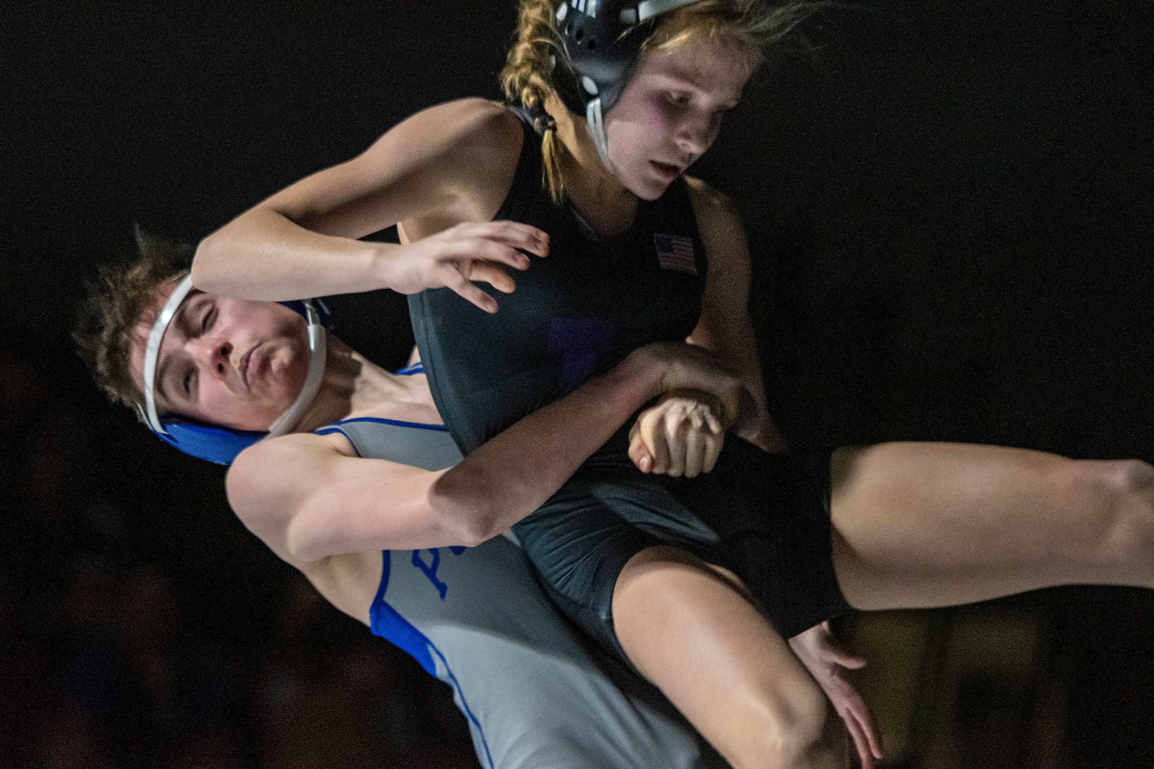 Pullman’s Bigham Cordova prepares to take Lewiston’s Joely Slyter to the ground Tuesday in the 113-pound weight class during a varsity wrestling match at Lewiston High.