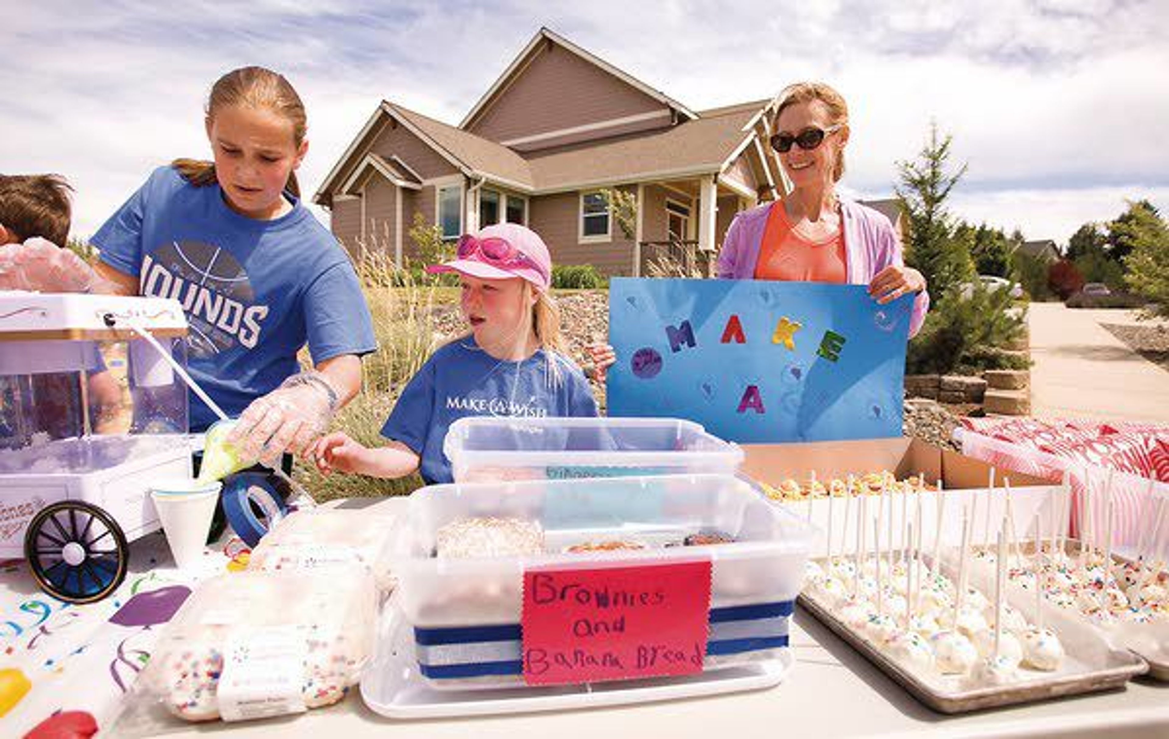 Marissa Carper, left, Shay Connell and Colleen Welter help customers at a lemonade and snack stand Monday in Pullman. The stand was raising money for the Make-A-Wish Foundation, which previously granted a wish to Shay.