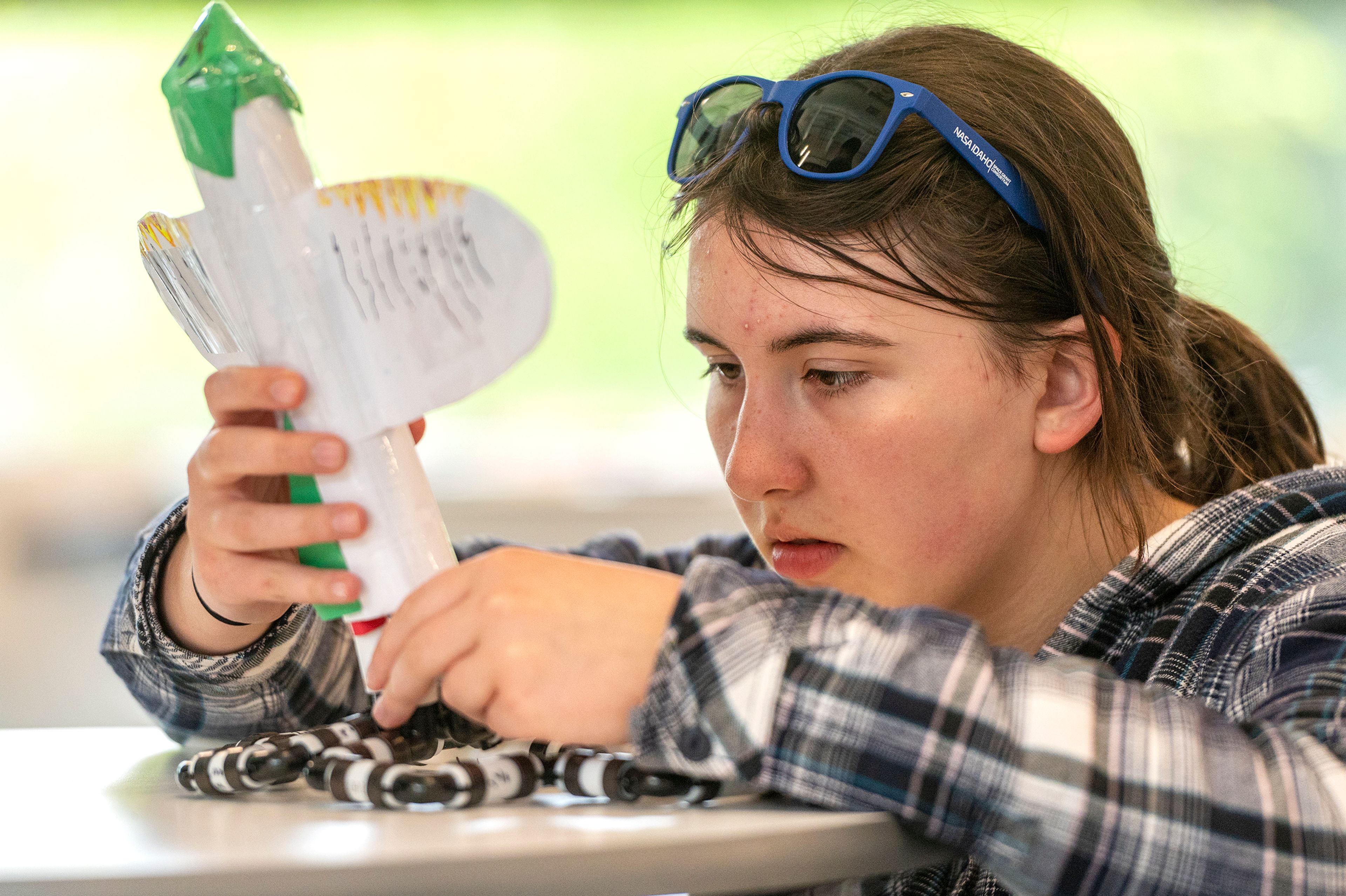 Annabelle Johnson, of Moscow, inspects her team’s rocket.