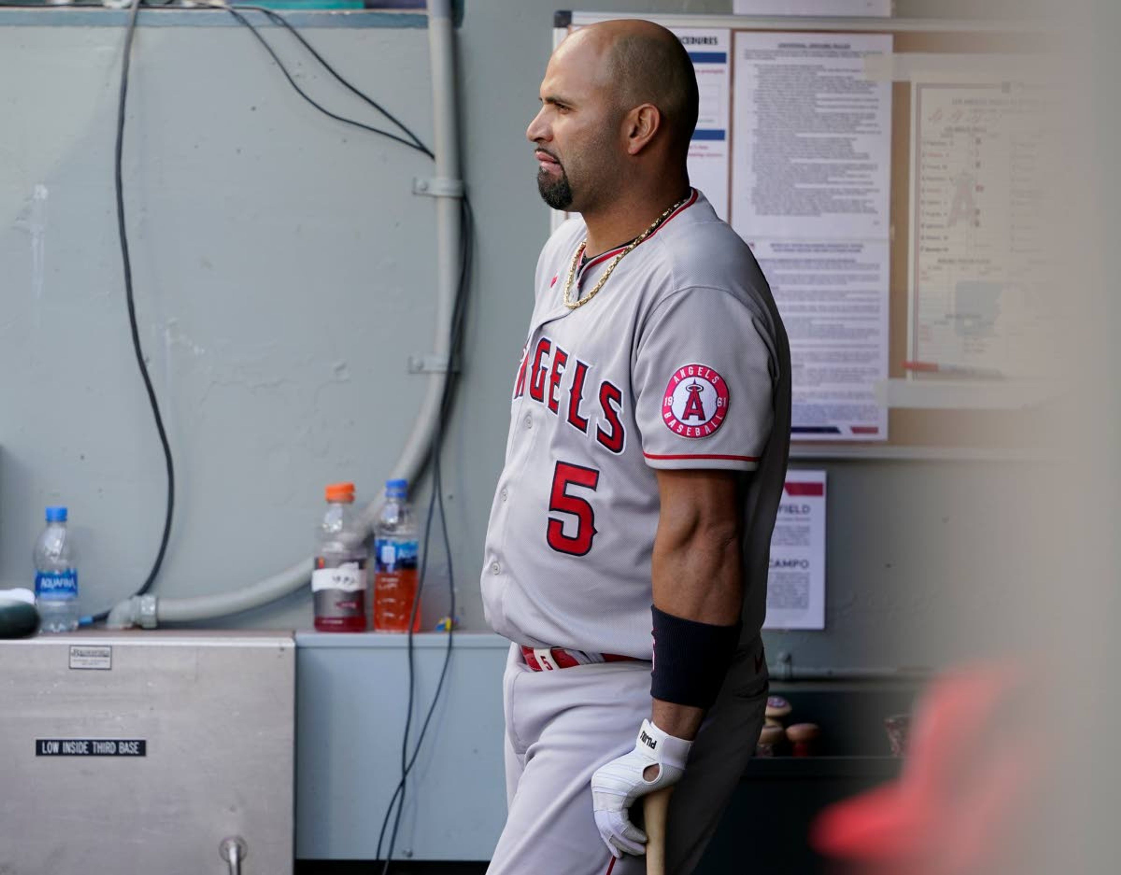 Los Angeles Angels Albert Pujols leans on his bat in the dugout during the eighth inning of a baseball game against the Seattle Mariners, Sunday, May 2, 2021, in Seattle. (AP Photo/Ted S. Warren)