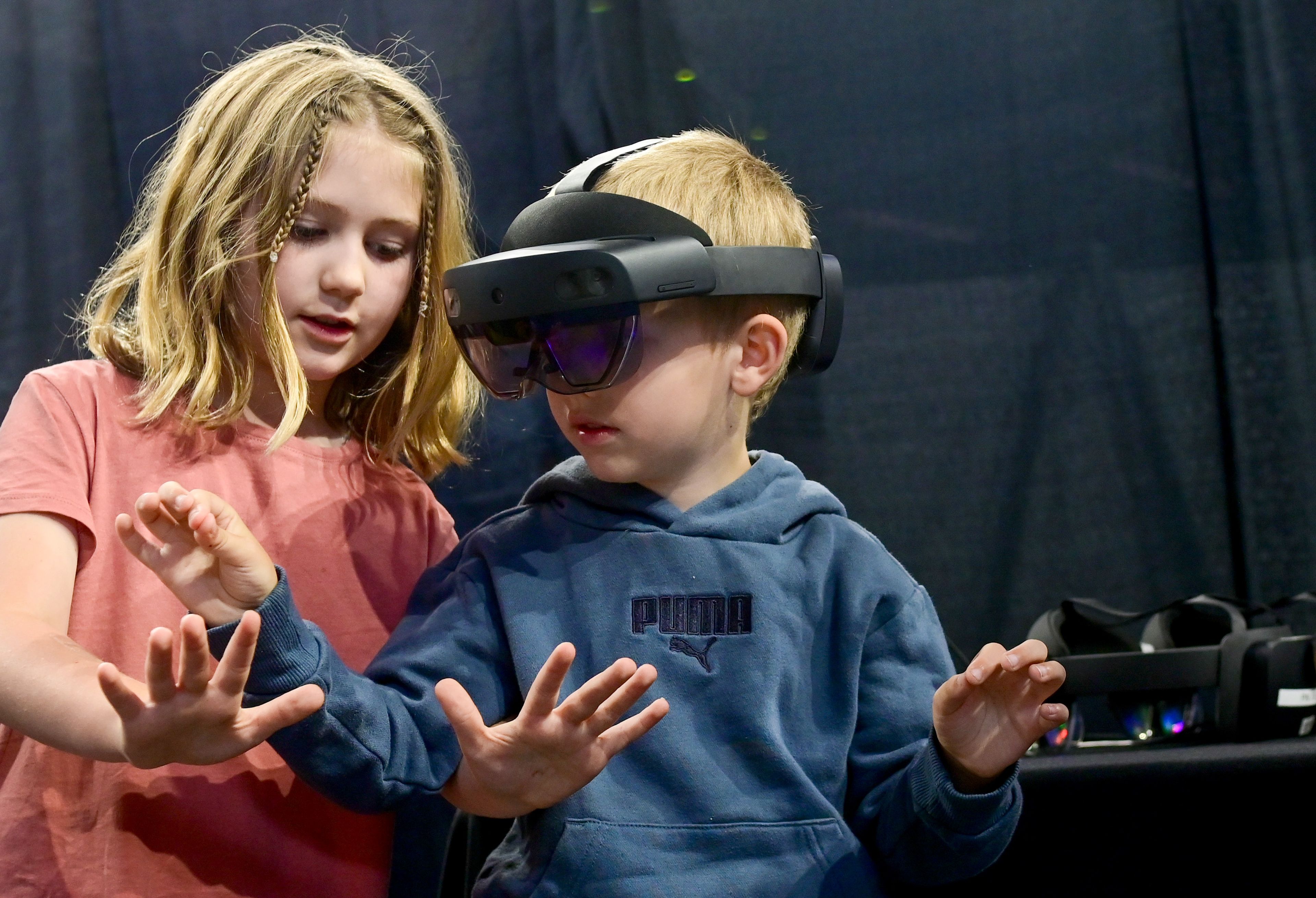 Lucy Sanchirico, left, 7, and Leo Sanchirico, 5, of Lewiston, experience a drawing program through augmented reality goggles brought to the Engineering Design EXPO by sponsor Idaho National Laboratory in Moscow on Friday. Lucy and Leo attended the event to see their older brother, senior mechanical engineering student at the University of Idaho Paul Sanchirico’s, capstone project at the EXPO.