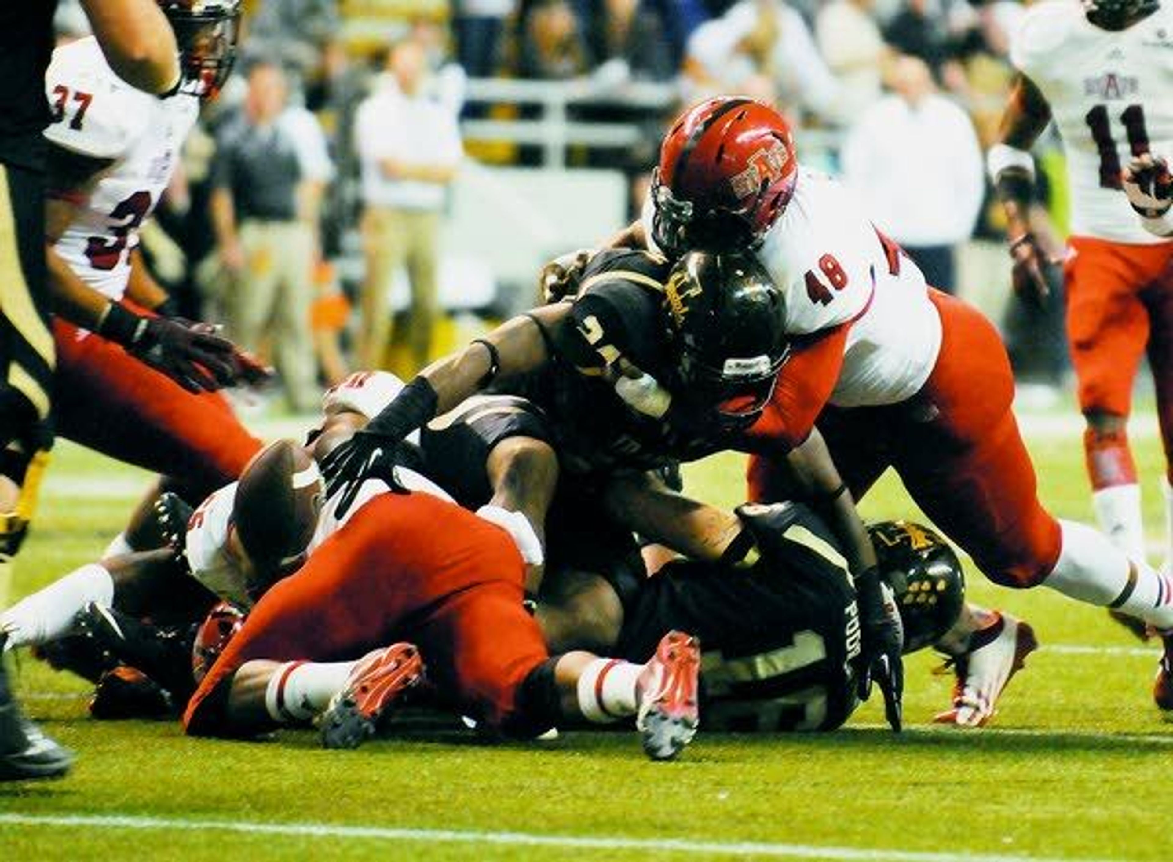 Idaho’s Jerrel Brown loses the football as Arkansas State’s Qushaun Lee stops him at the line of scrimmage Saturday in Moscow. Idaho. (AP Photo/Lewiston Tribune, Kyle Mills)