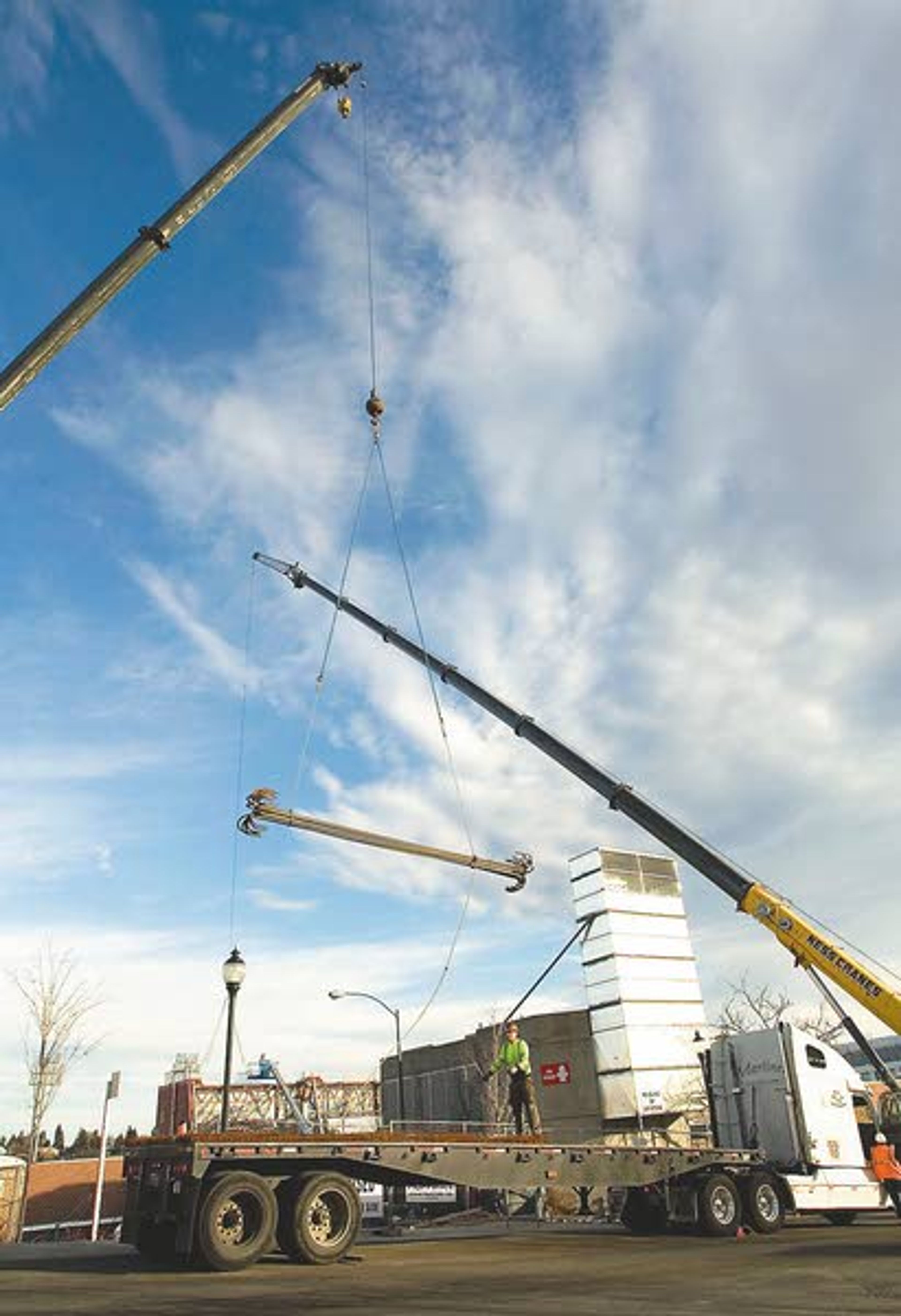 A crane lifts supplies off of a truck on the southside of Martin
Stadium in Pullman on Wednesday. The work is part of an $80 million
project to create a new press box and luxury seats.