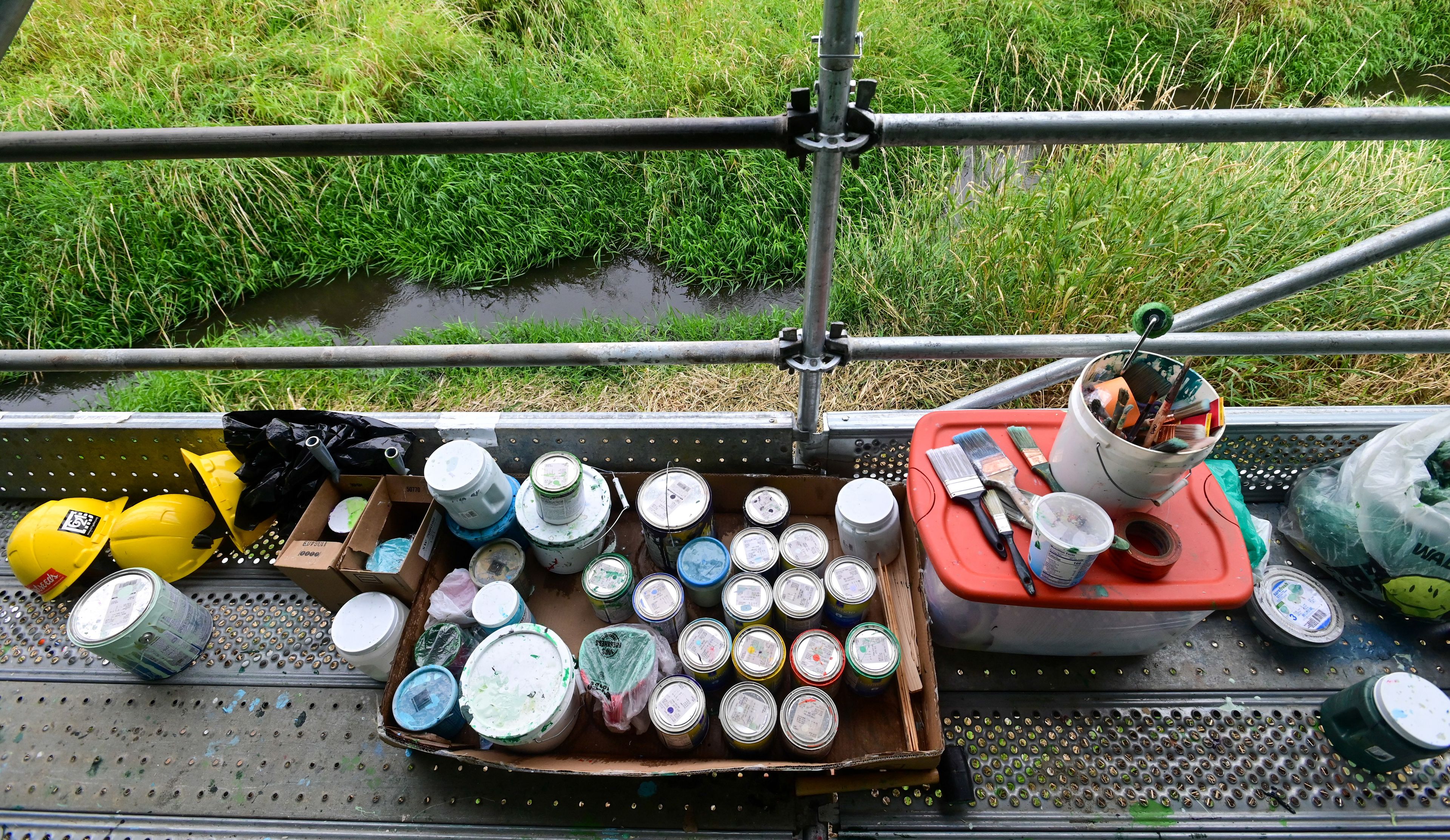 Supplies for a new mural in downtown Pullman sits along the edge of the multi-level scaffolding set up for the project.