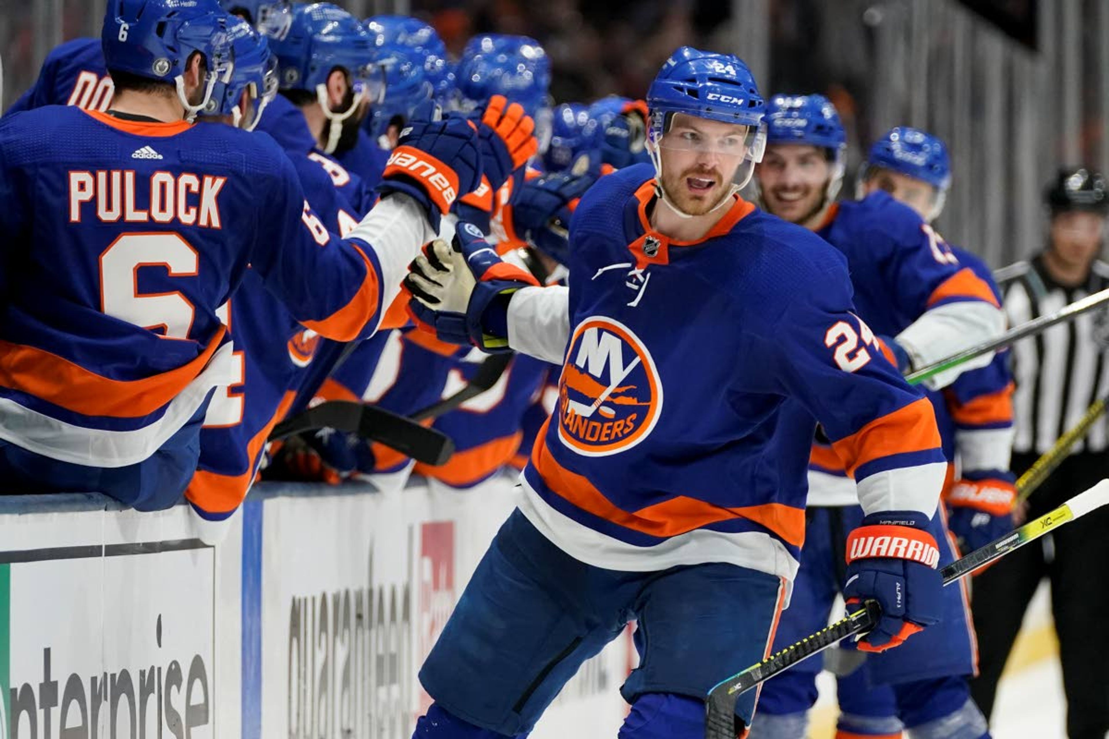 New York Islanders defenseman Scott Mayfield (24) celebrates with teammates after scoring against the Tampa Bay Lightning during the third period of Game 6 of the NHL hockey Stanley Cup semifinals, Wednesday, June 23, 2021, in Uniondale, N.Y. (AP Photo/Frank Franklin II)