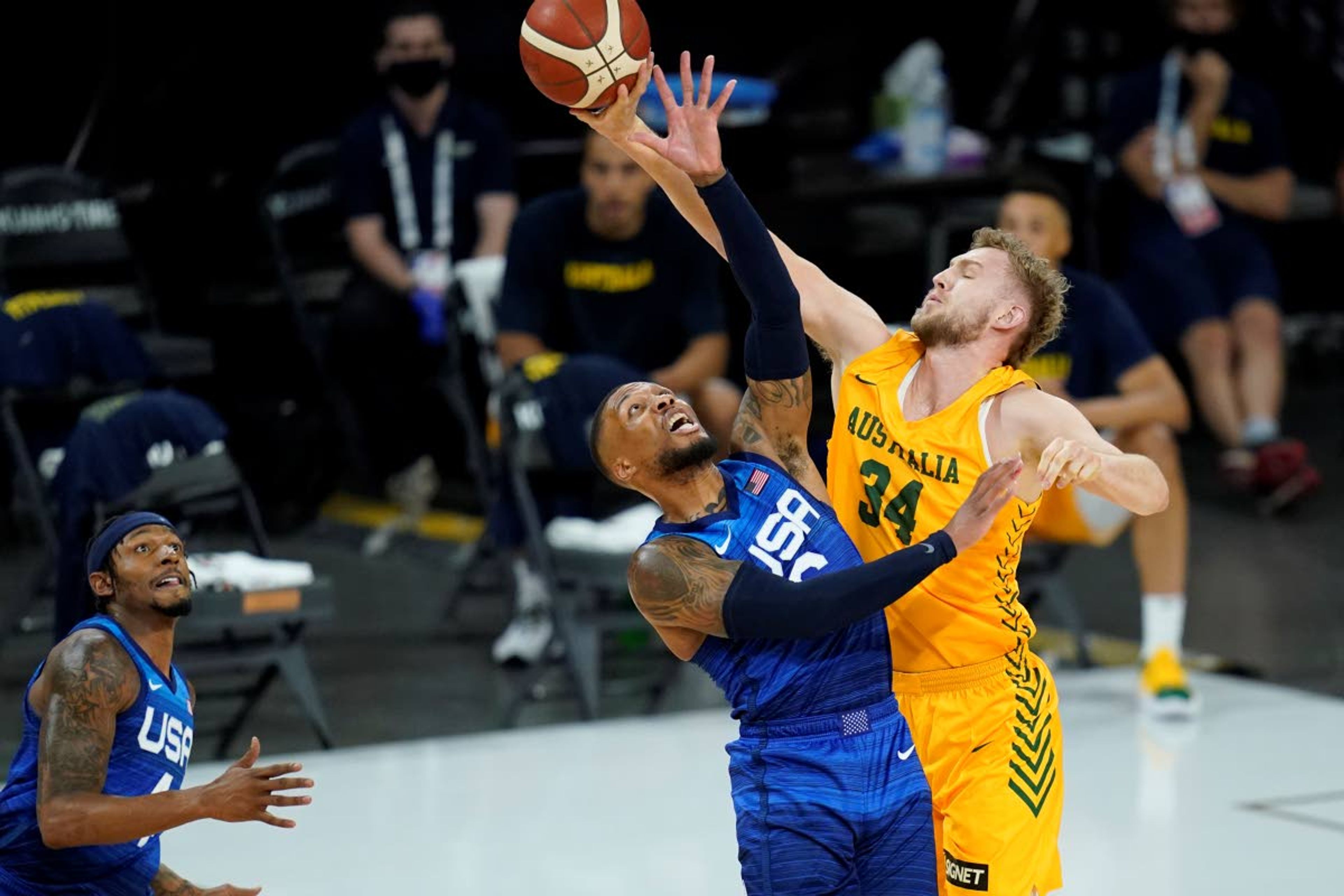 United States' Damian Lillard, left, and Australia's Jock Landale battle for the ball during an exhibition basketball game Monday, July 12, 2021, in Las Vegas. (AP Photo/John Locher)