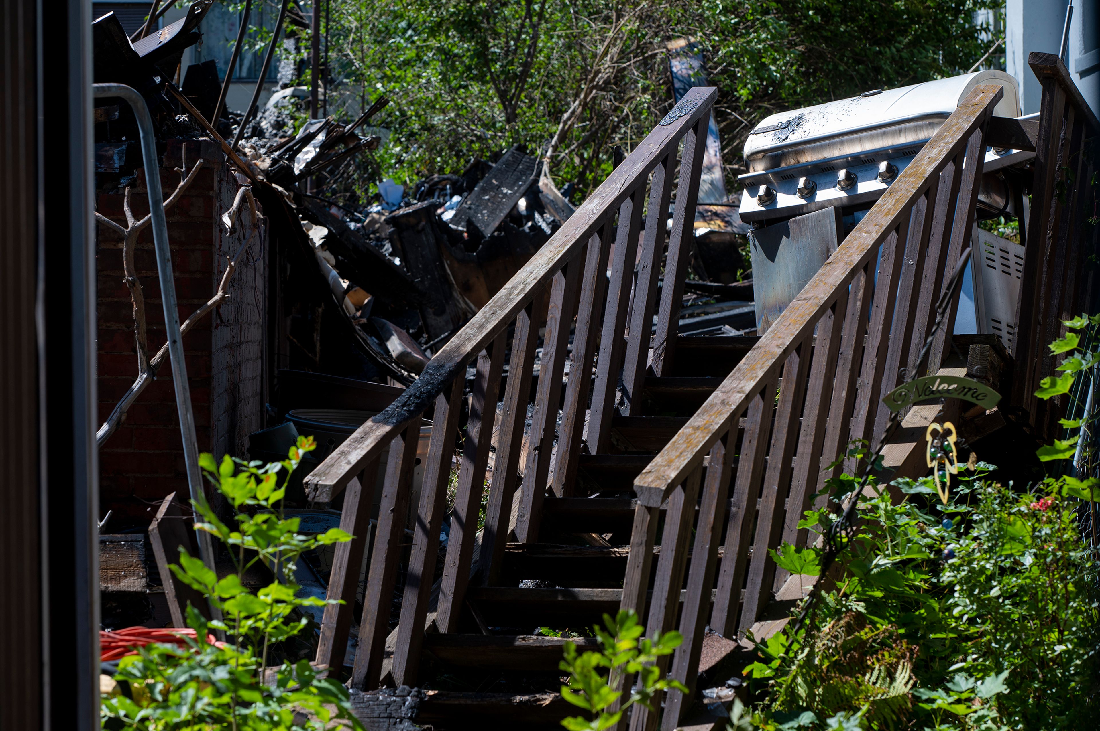 Charred stairs leading to a grill are seen after a house fire on the 200 block of Thorn Street in Colfax on Monday. The fire occurred Saturday afternoon and burned through the night.