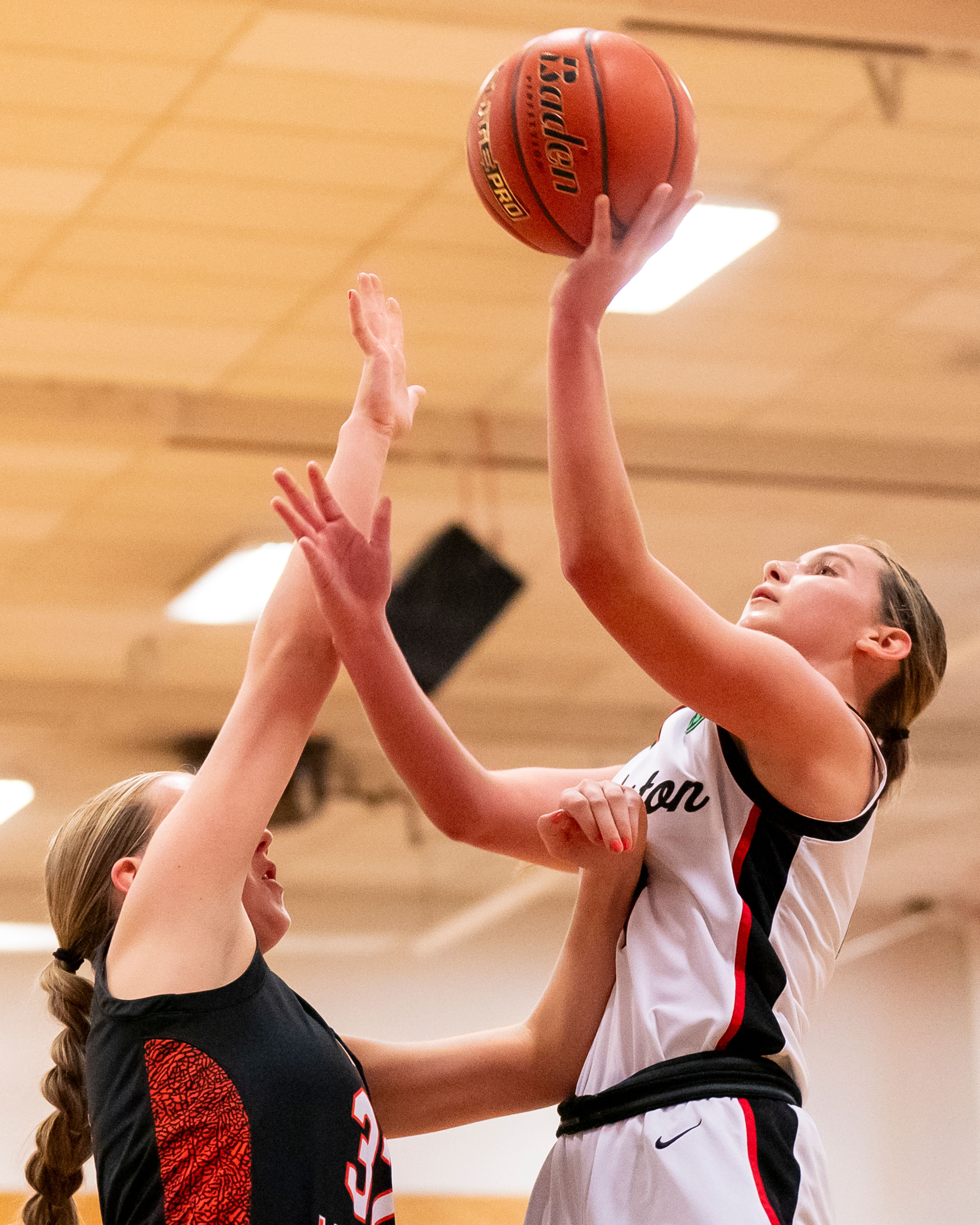 Clarkston’s Ella Leavitt, right, shoots the ball during a girls 2A district championship game against West Valley on Feb. 17 at Clarkston High School.