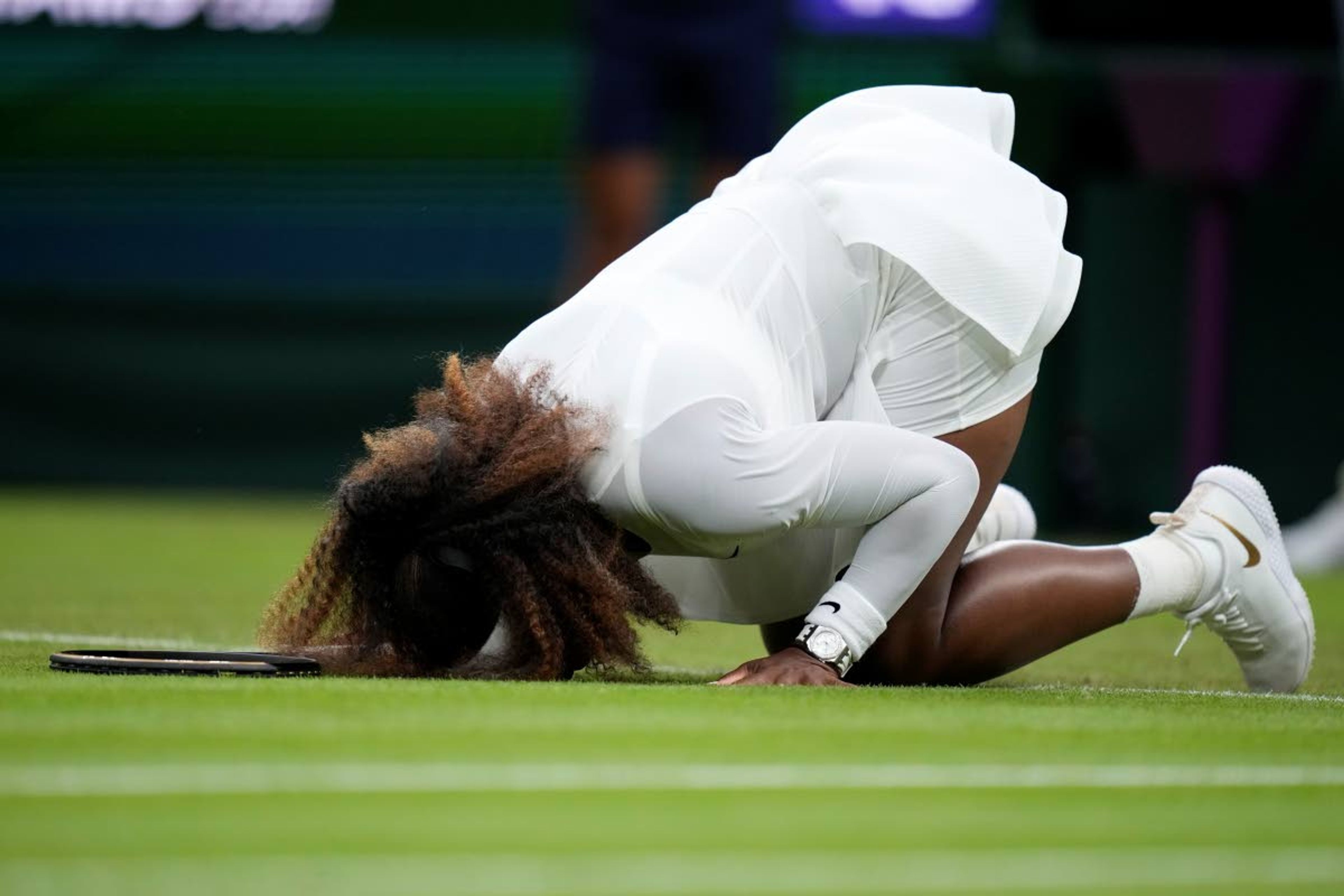 Associated PressSerena Williams of the U.S. falls to the ground Tuesday during the women’s singles first round match against Aliaksandra Sasnovich of Belarus on day two of the Wimbledon Tennis Championships in London.