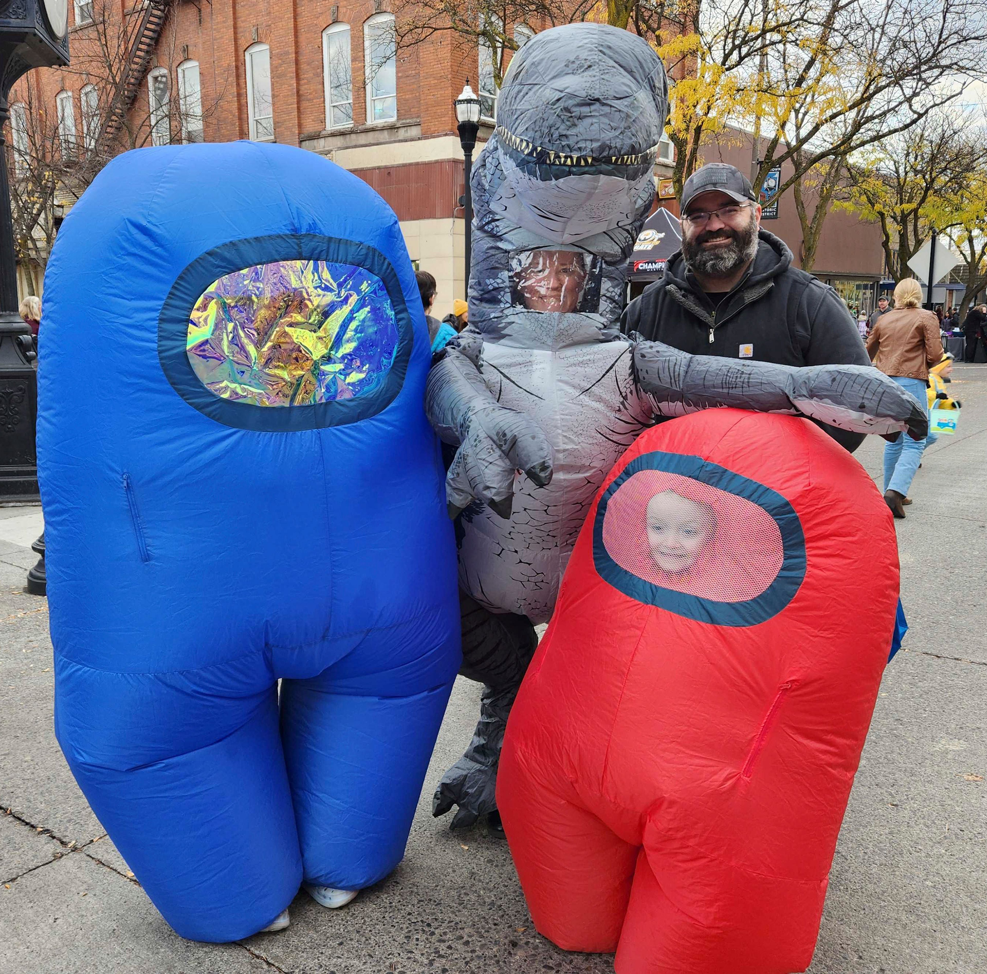 David Dukes, from left, April Dukes, Jarrad Dukes and Matthias Dukes attend Moscow's Downtown Trick or Treat event Thursday, with the kids dressed as characters from Among Us and a dinosaur.