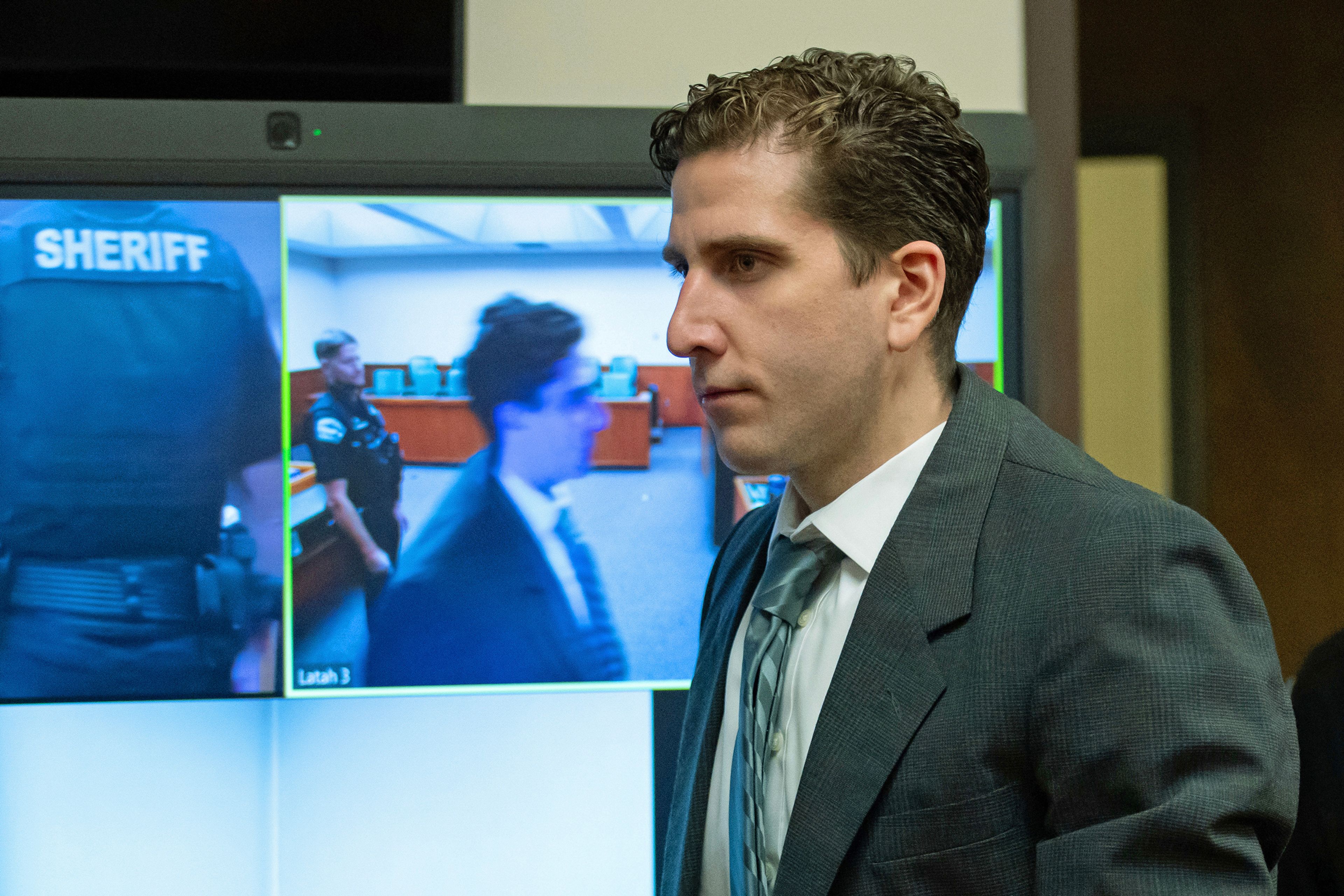 Bryan Kohberger, who is accused of killing four University of Idaho students in November 2022, walks past a video display as he enters a courtroom to appear at a hearing in Latah County District Court, Wednesday, Sept. 13, 2023, in Moscow, Idaho. Kohberger's attorneys want cameras banned from the courtroom, contending that news coverage of the criminal proceedings has violated a judge's orders and threatens his right to a fair trial. (AP Photo/Ted S. Warren, Pool)