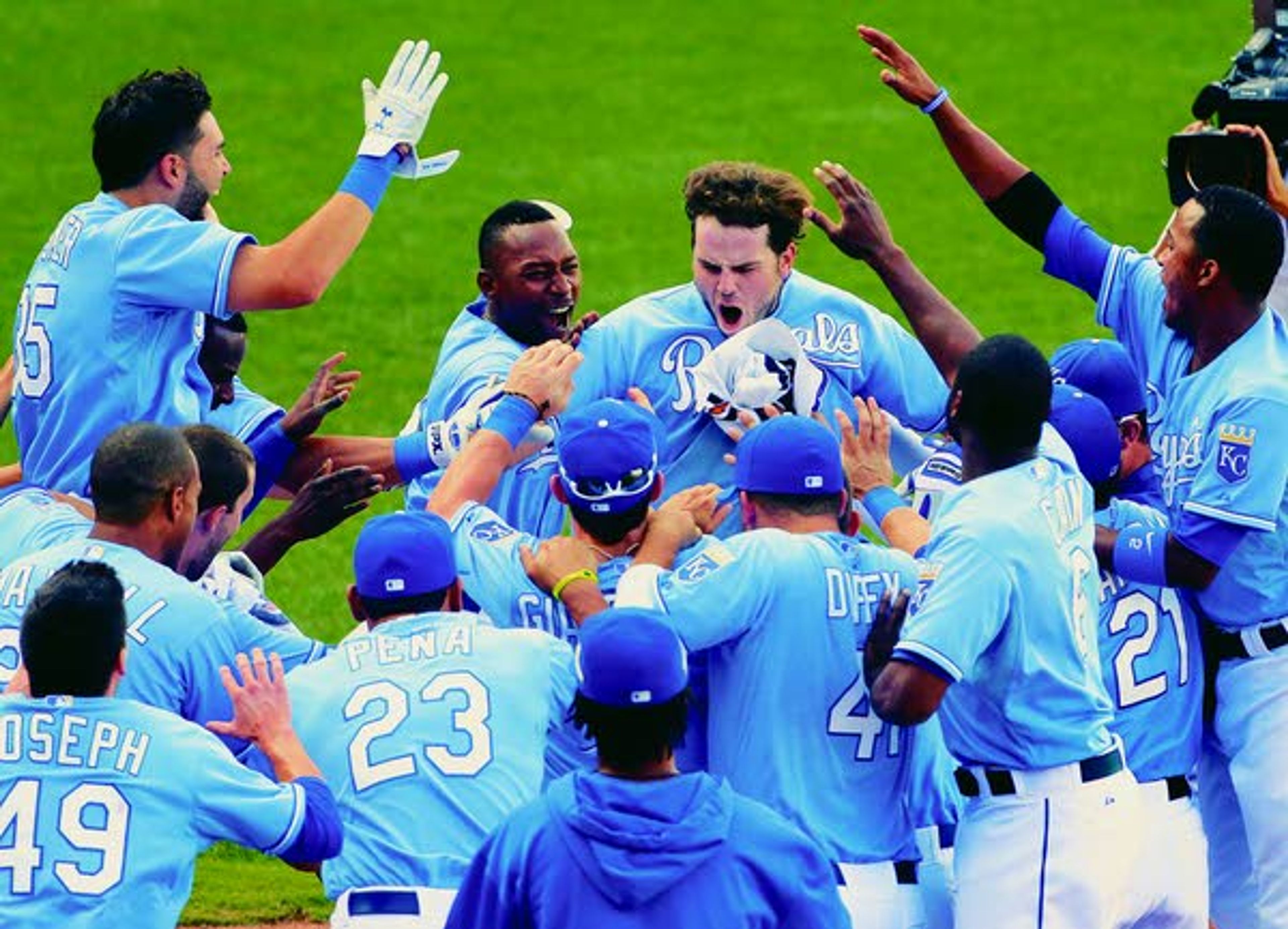 Royals’ Mike Moustakas, center, celebrates with teammates after hitting a solo home run in the 13th inning to win Thursday’s game against the Mariners in Kansas City, Mo. The Royals won the game 7-6. (AP Photo/Charlie Riedel)