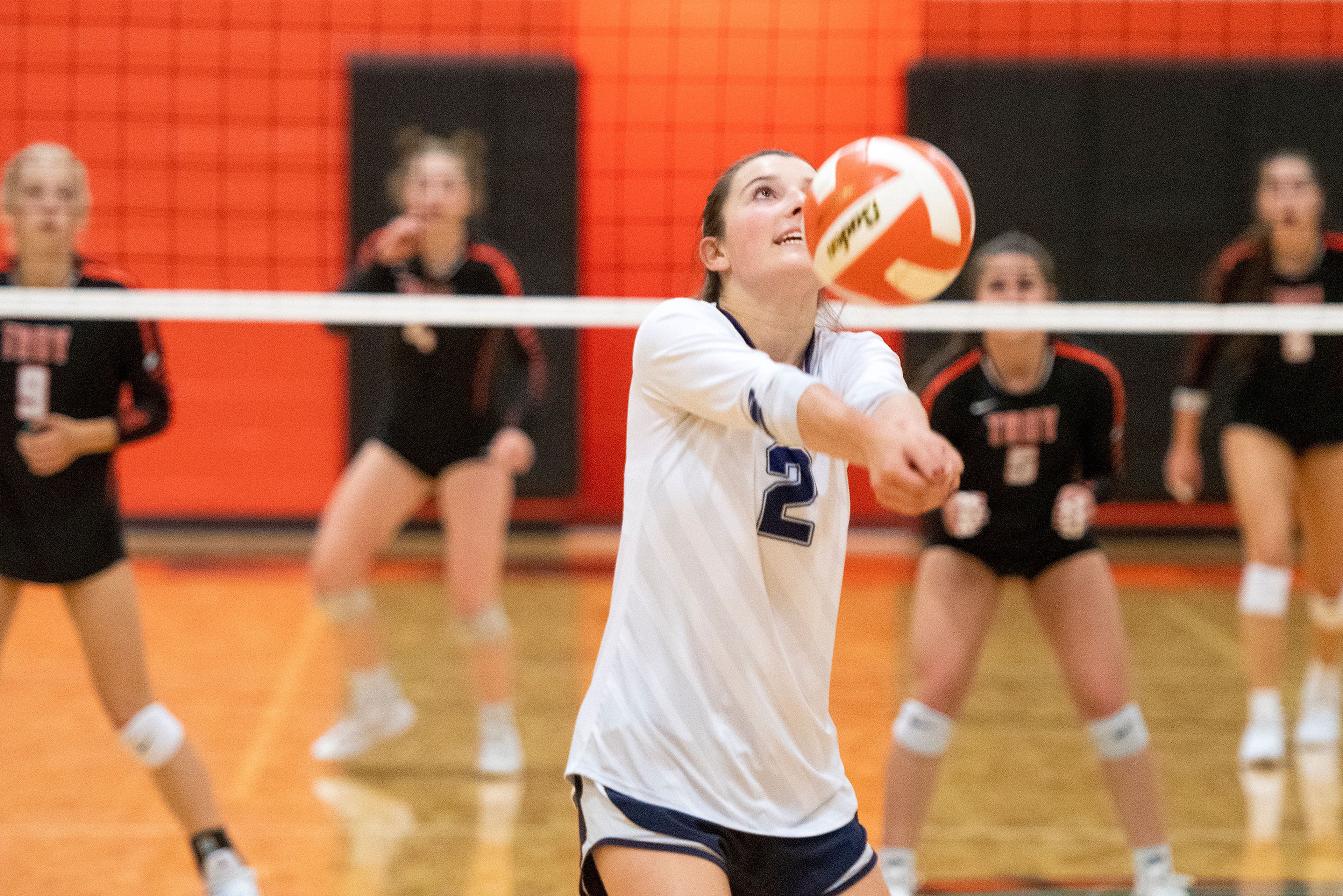 Logos’ Lucia Spencer (2) bumps the ball to a teammate during a Whitepine League matchup against Troy at Troy High School on Tuesday.