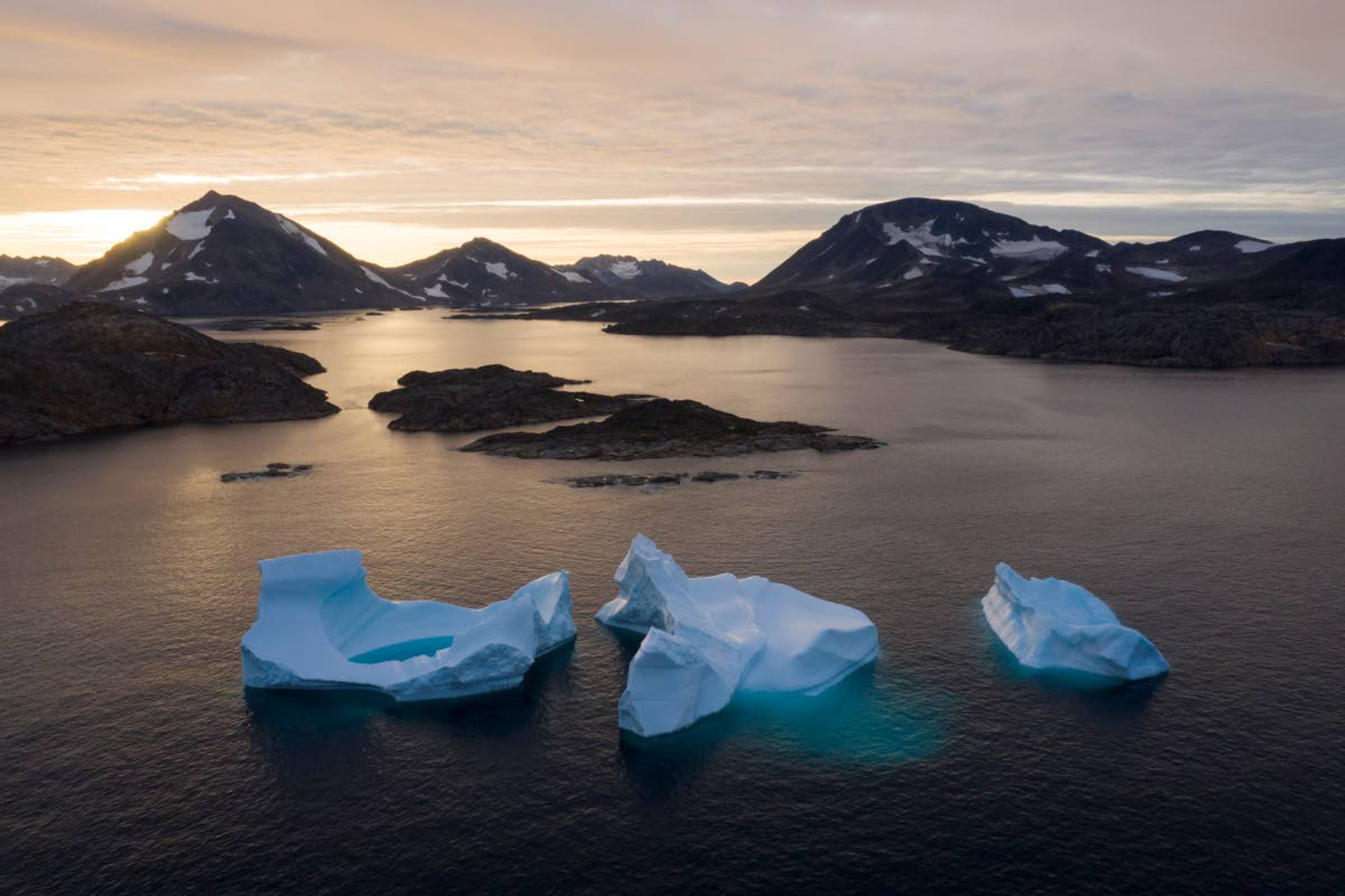 Felipe Dana/AP file photoIcebergs float away in August 2019 as the sun rises near Kulusuk, Greenland. According to a study released Thursday, Greenland lost a record amount of ice during an extra warm 2019, with the melt massive enough to cover California in more than 4 feet of water.