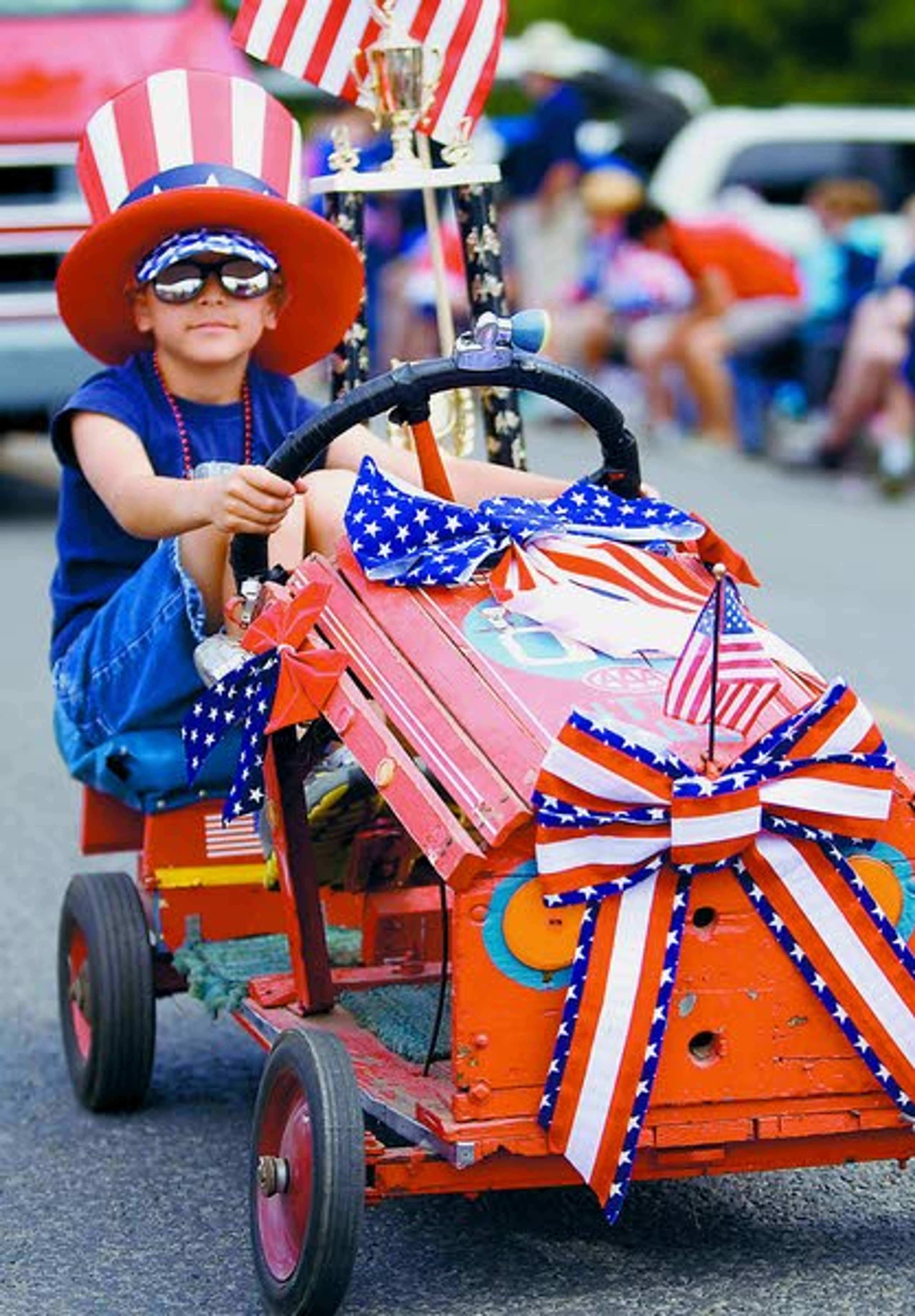 David Trail of Clarkston drives a go-cart in the Johnson Independence Day Parade on Saturday. The go-cart was built in the 1940s or 1950s by Trail's grandfather, David Trail of Moscow. (eds: both people are named David Trail.)