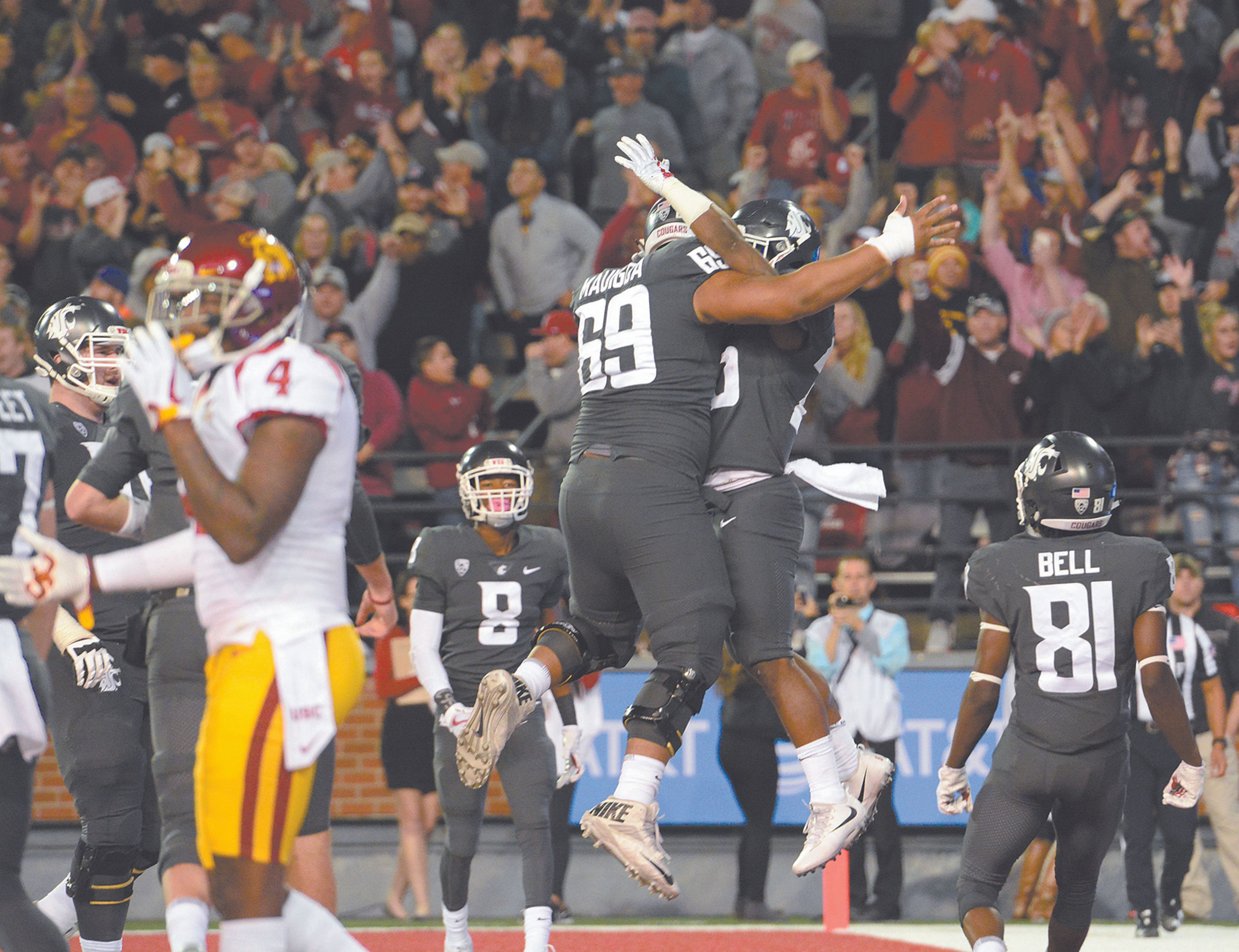 Washington State center Frederick Mauigoa celebrates with James Morrow after Morrow scampered into the end zone for a touchdown late in the second quarter of a Pac-12 Conference football game on Friday night at Martin Stadium in Pullman.