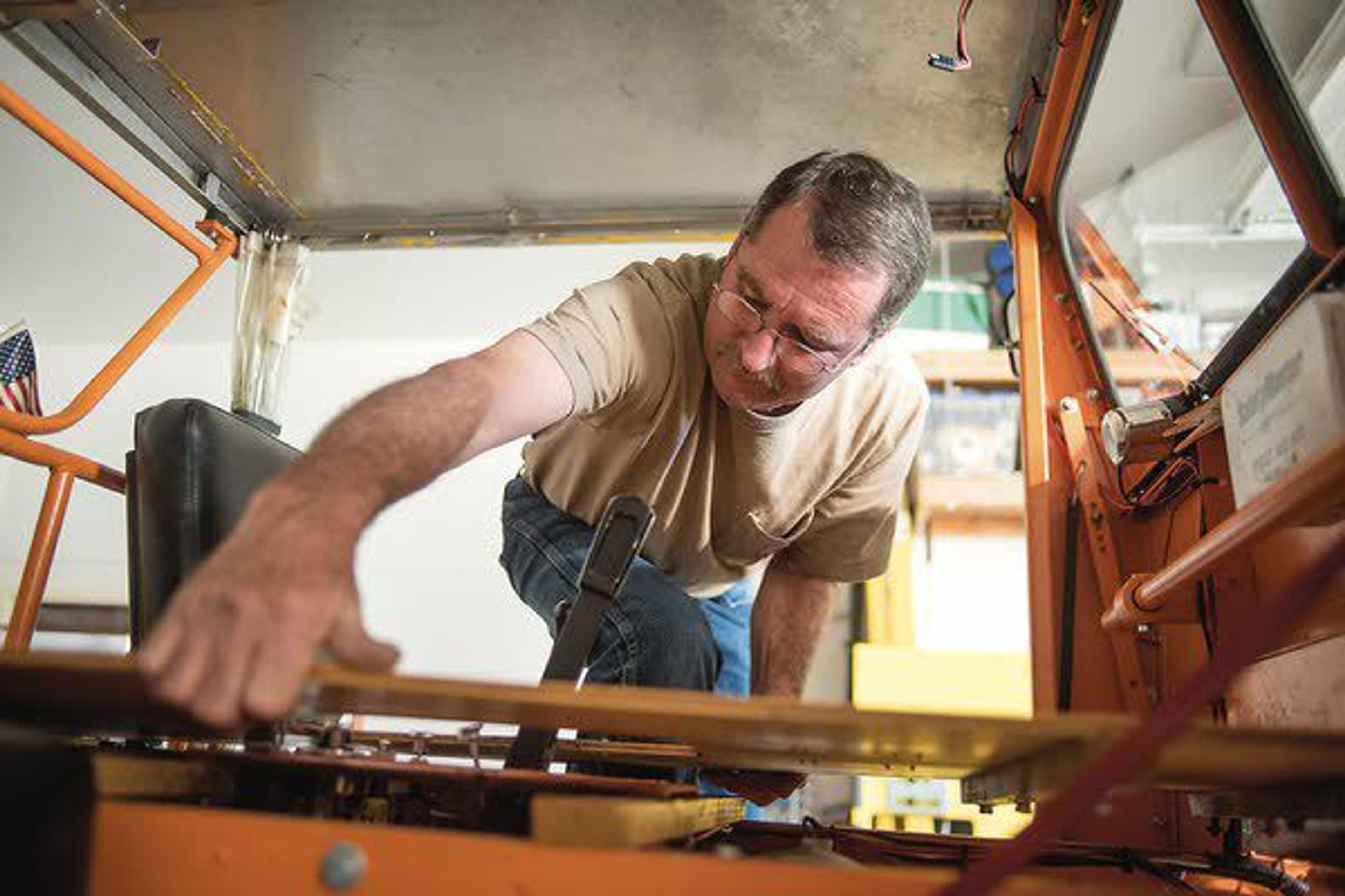 Roger Farrell takes off a top plate, revealing his speeder’s gearbox Wednesday in Albion. The speeder, Li’l Odge, used to be full of weeds and in pieces until Farrell fixed it up.