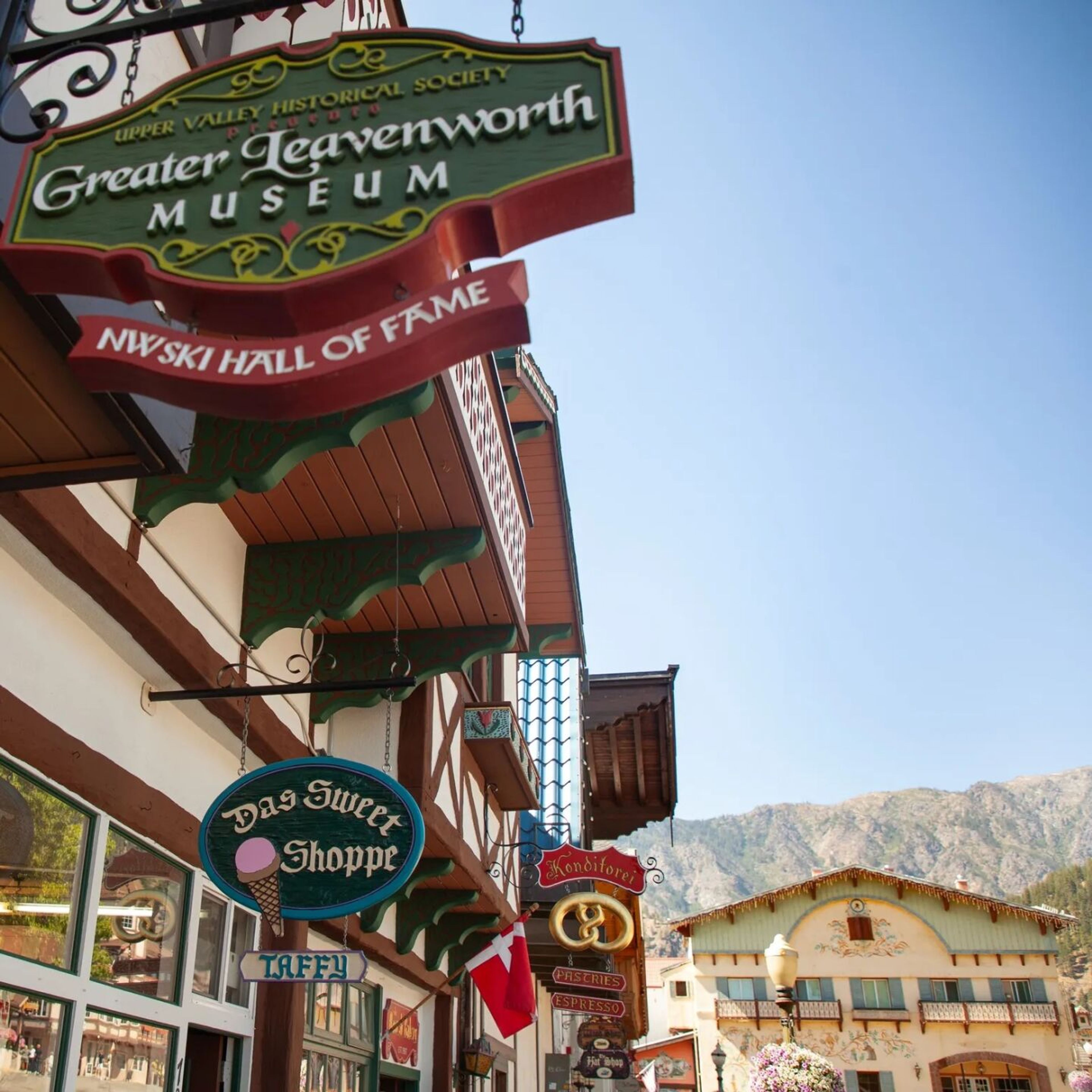 Typical shop signs on Front Street in Leavenworth. (“Das Sweet Shoppe” does not make sense in German, and the doughy arms of a pretzel do not have an arch at the end).