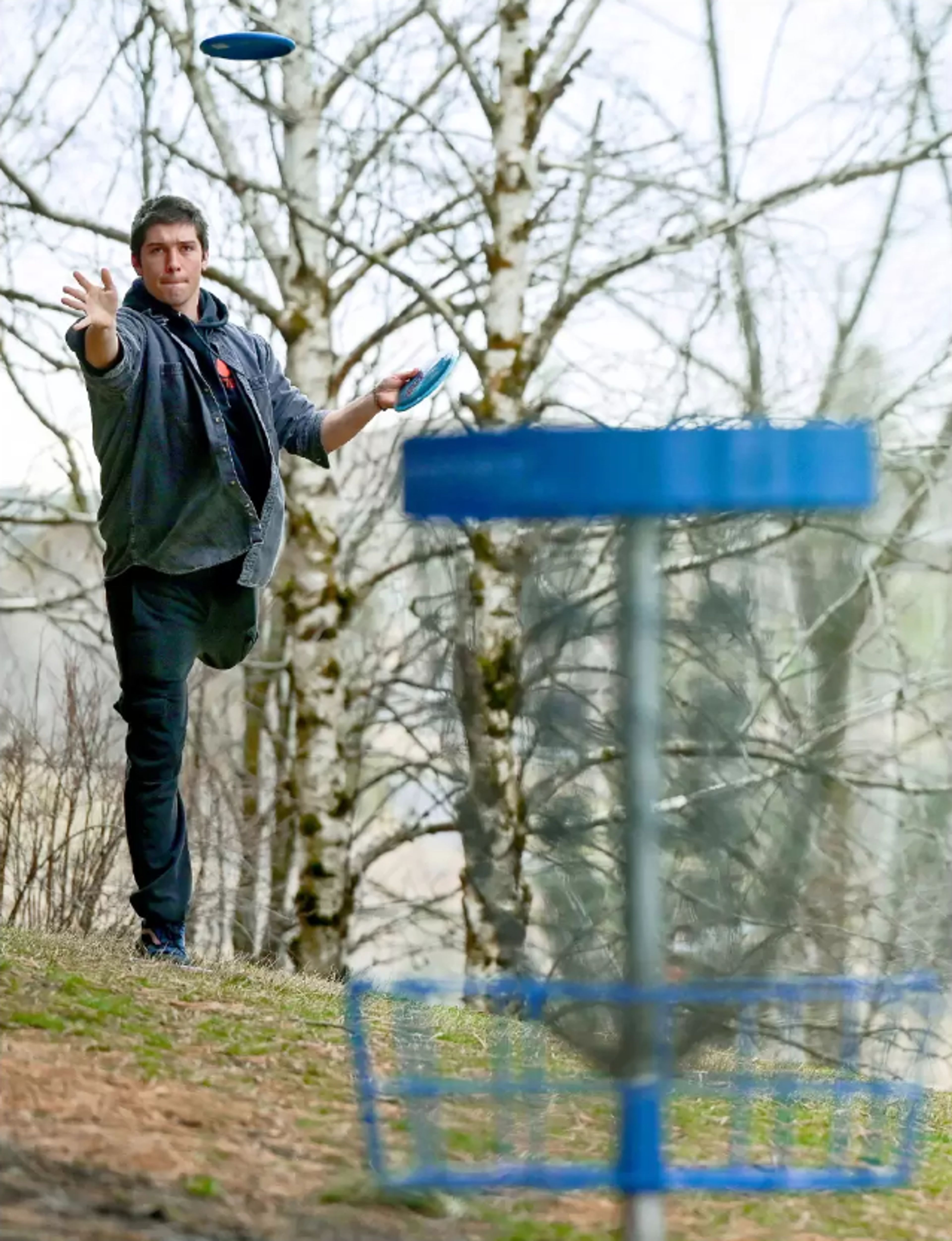 Leroy Gustafson, visiting from out of state, throws a disc toward a basket Monday at Sunnyside Park in Pullman.