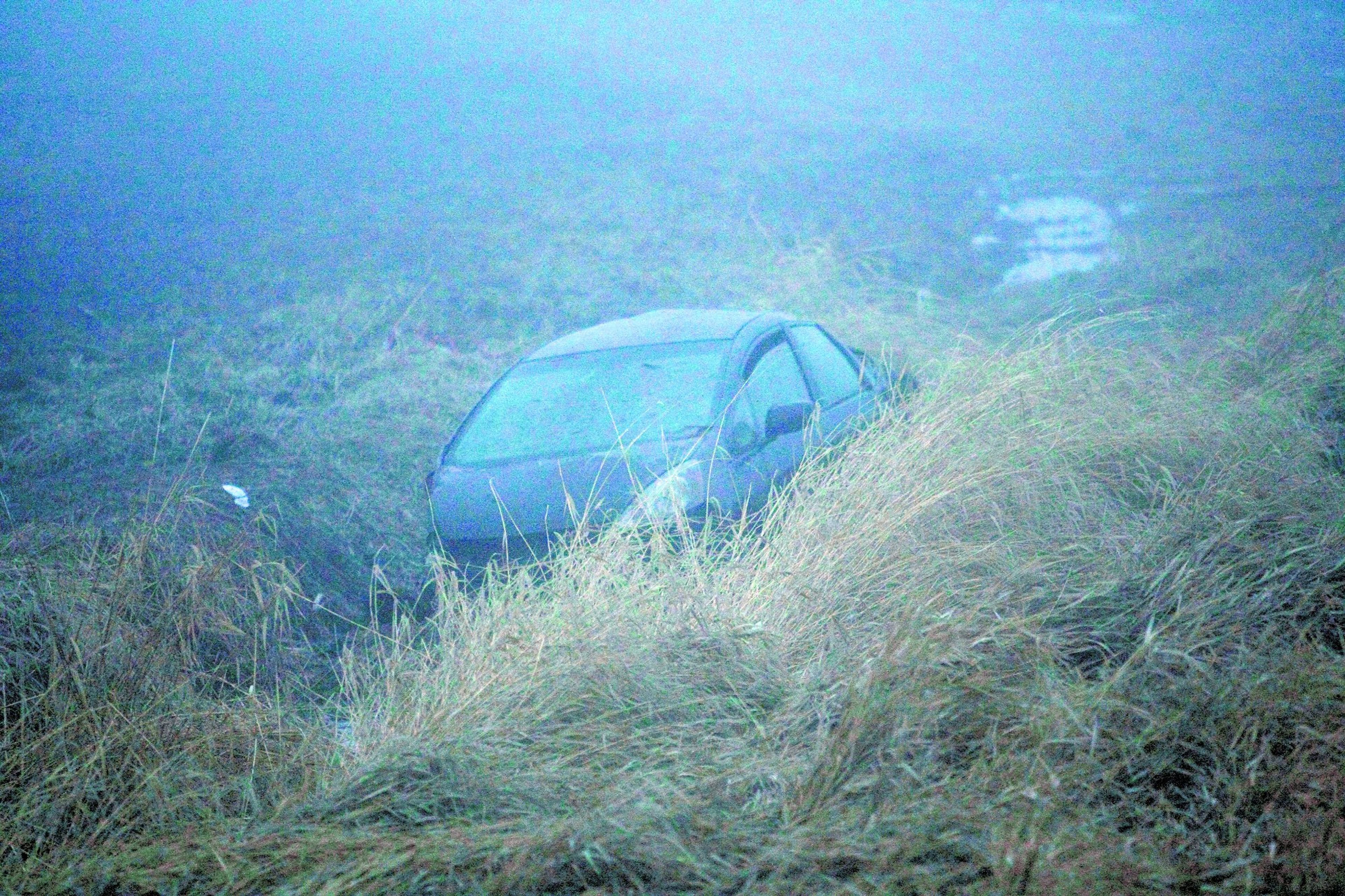 The car driven by Moscow shooting suspect John Lee rests in a ditch along Highway 195 near Colfax.