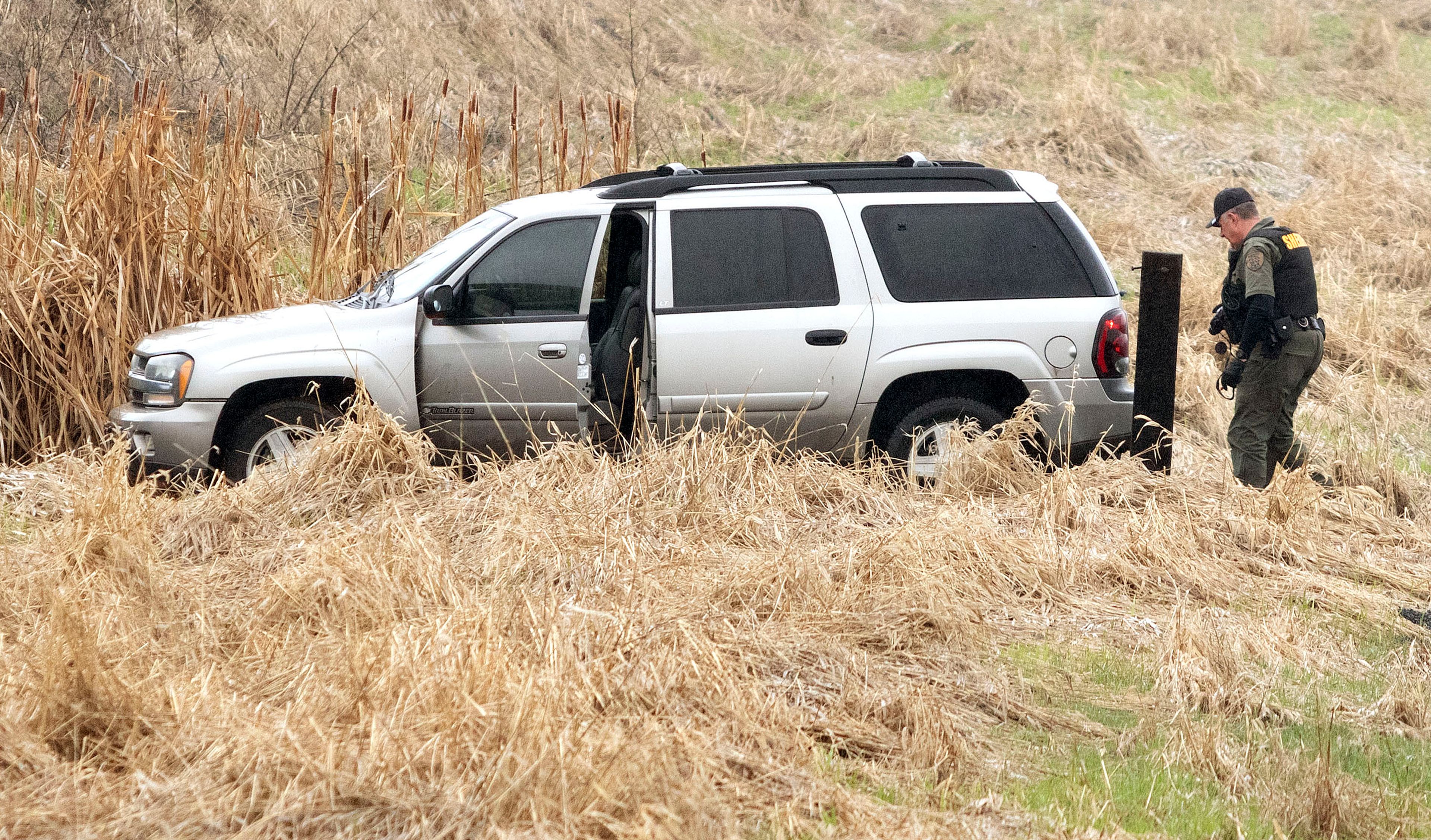 A Whitman County Sheriff's deputy investigates a stolen Chevrolet Blazer that was found abandoned on Sunshine Road on Monday east of Pullman. The vehicle was stolen from an employee of Bud Hut by a man who robbed the store at gunpoint.