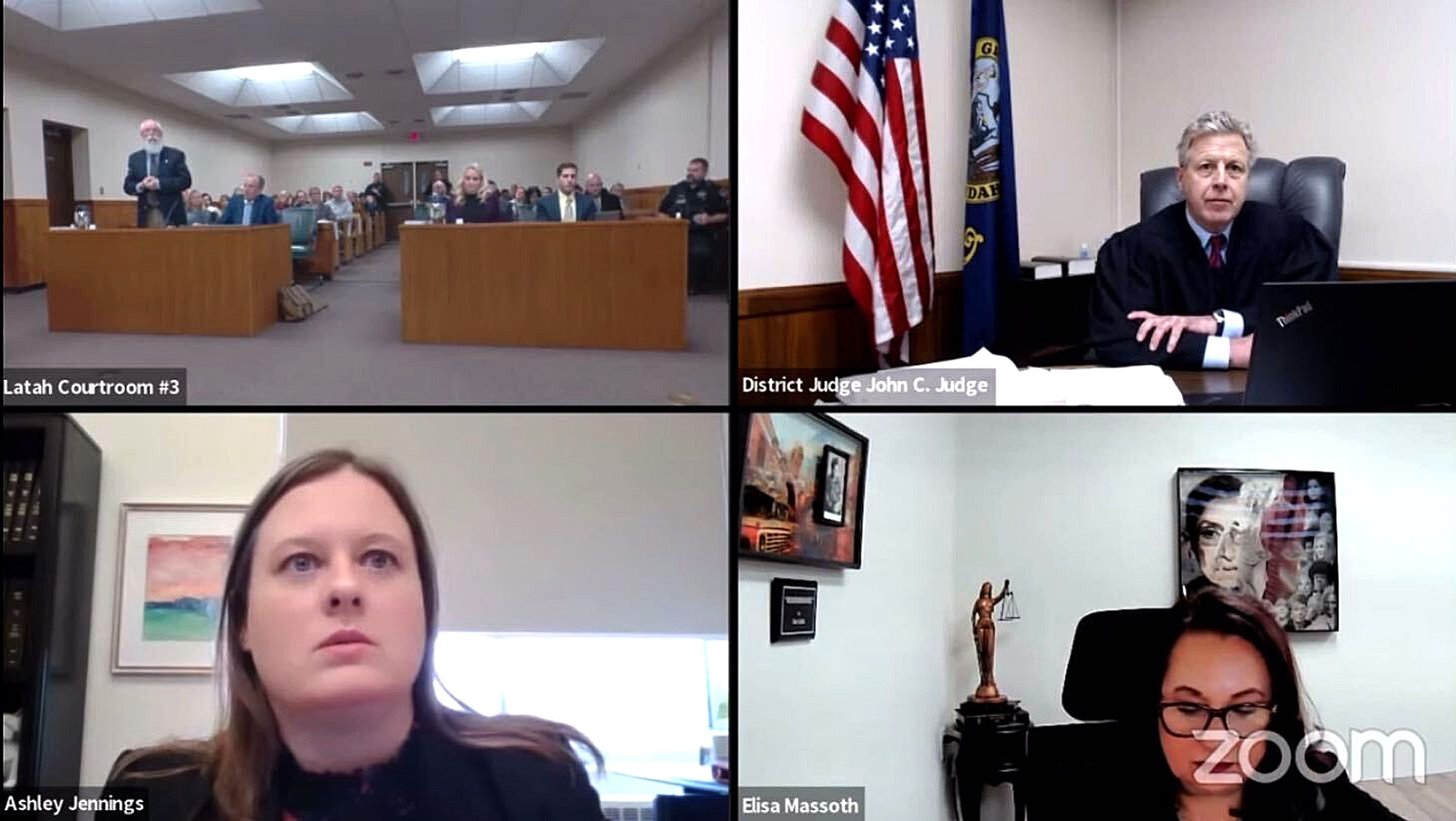 This screenshot take from video shows Friday's hearing in the Bryan Kohberger case at the Latah County Courthouse in Moscow. In the upper left screen are the prosecution and defense tables and in the upper right screen is Judge John Judge.