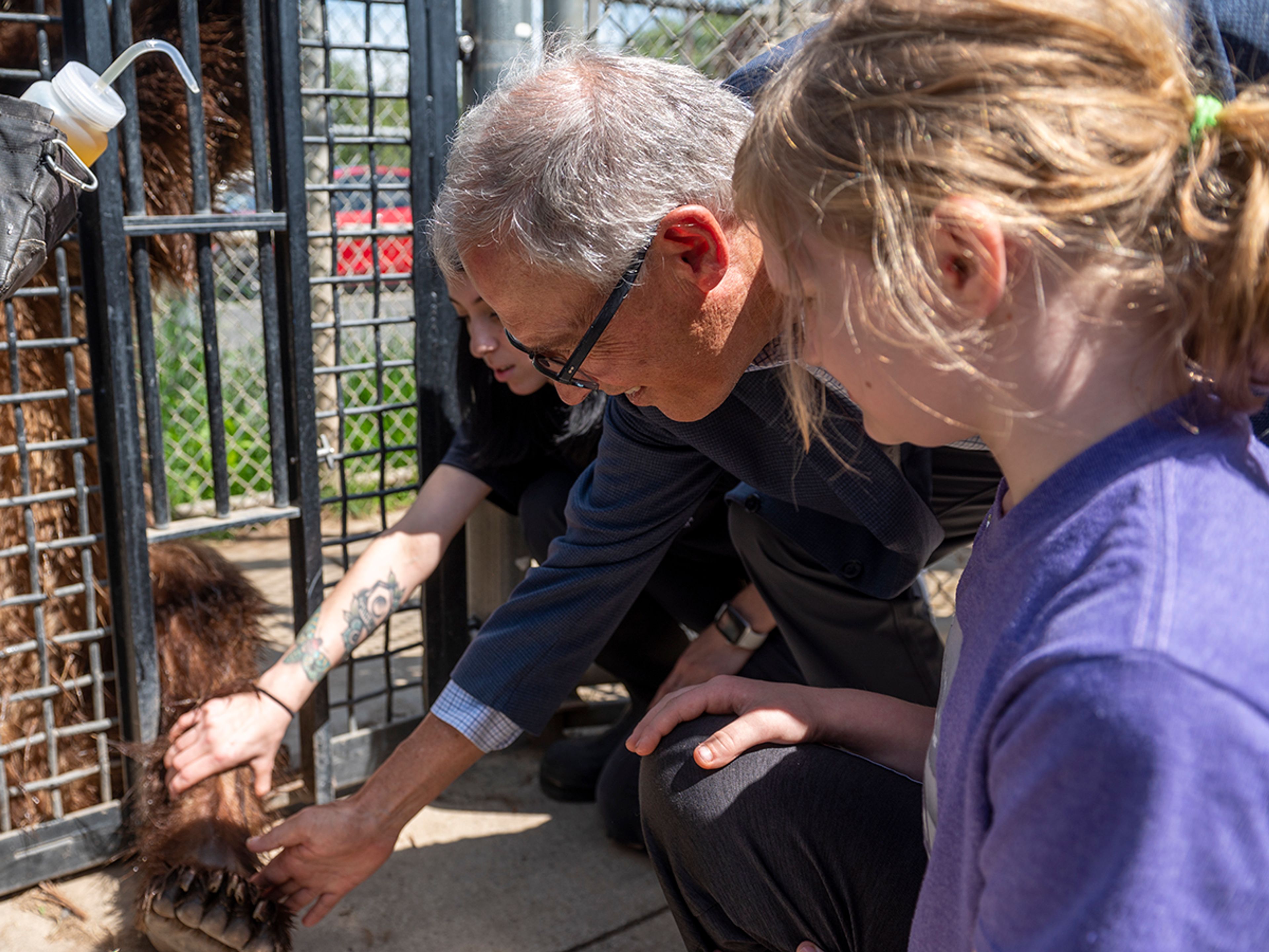 Washington Gov. Jay Inslee pets a grizzly bear’s foot while touring Washington State University’s Bear Center with his granddaughter Thursday afternoon in Pullman.