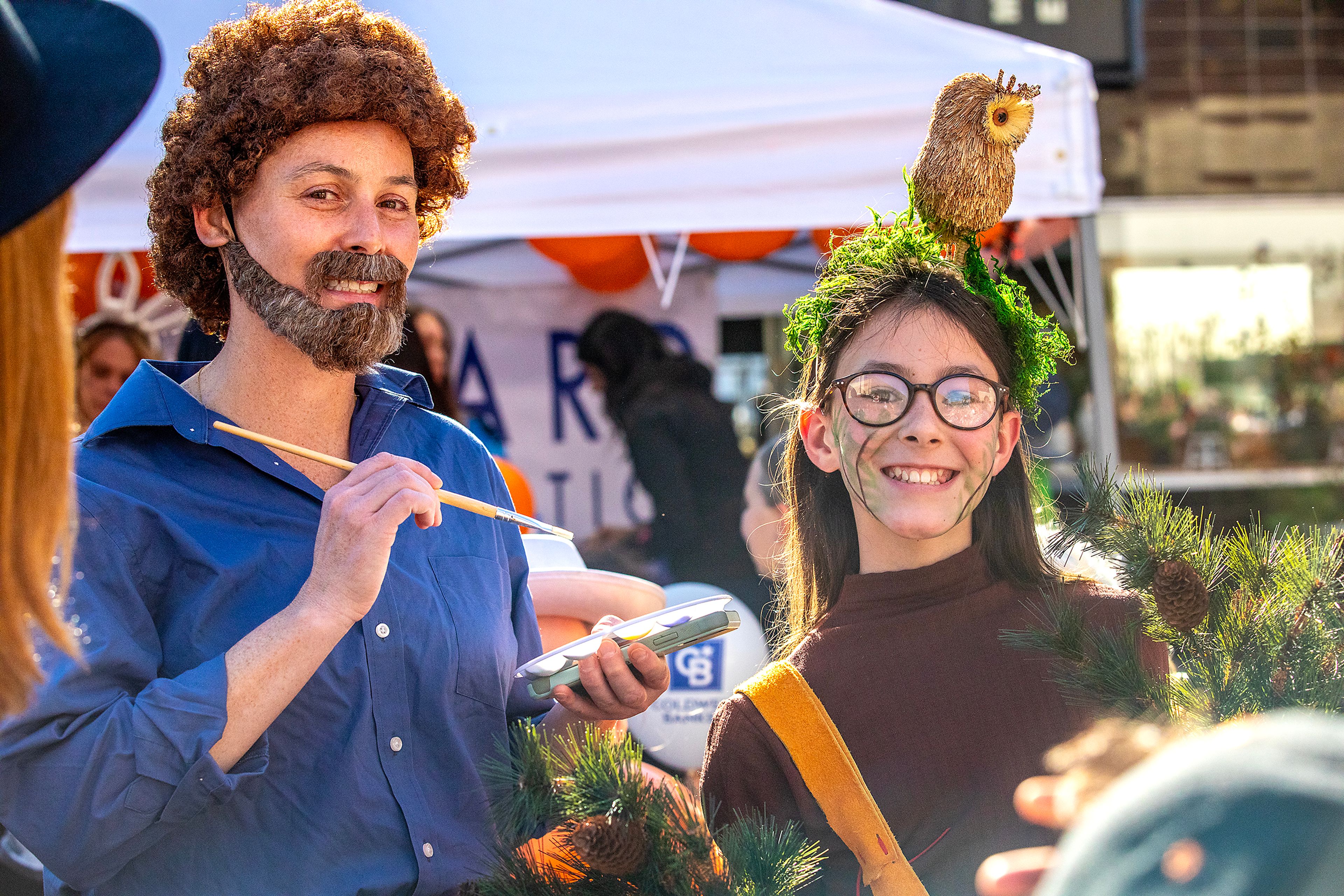 Vanessa Stedman, left, and Lena Stedman, 11, dress as Bob Ross and a happy little tree Saturday at Pumpkin Palooza in downtown Lewiston.,