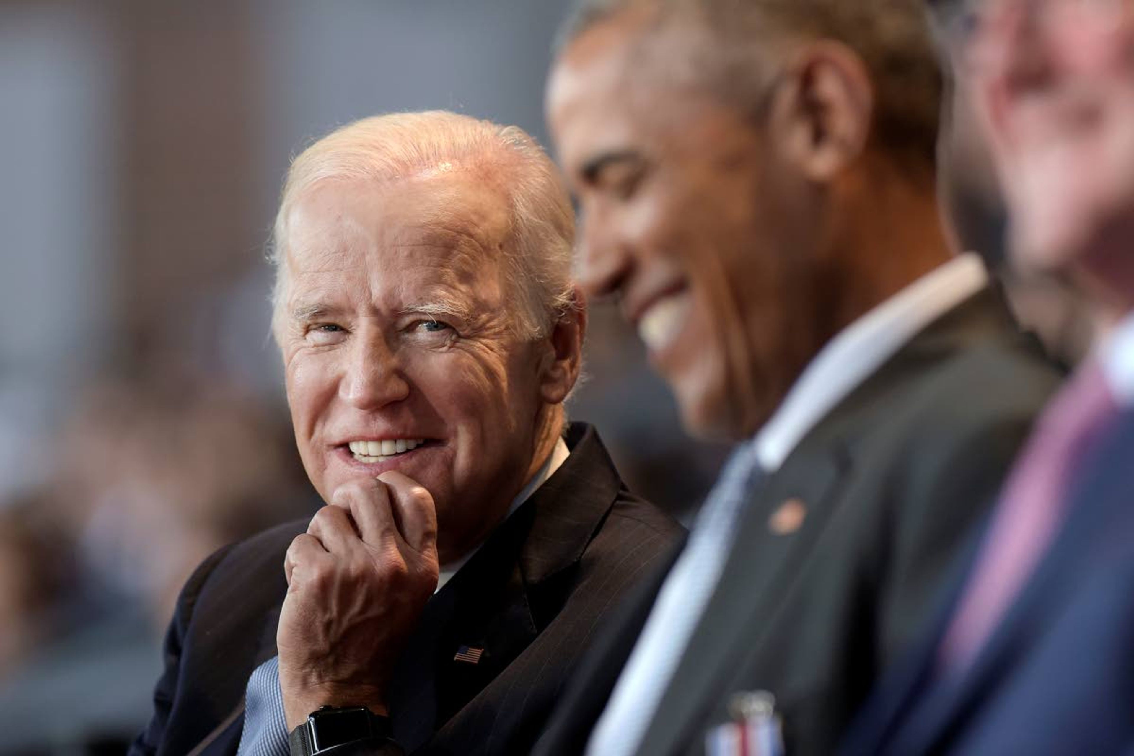 FILE - In this Jan. 4, 2017 file photo, Vice President Joe Biden, left, watches President Barack Obama, center, at Conmy Hall, Joint Base Myer-Henderson Hall, Va. (AP Photo/Susan Walsh)