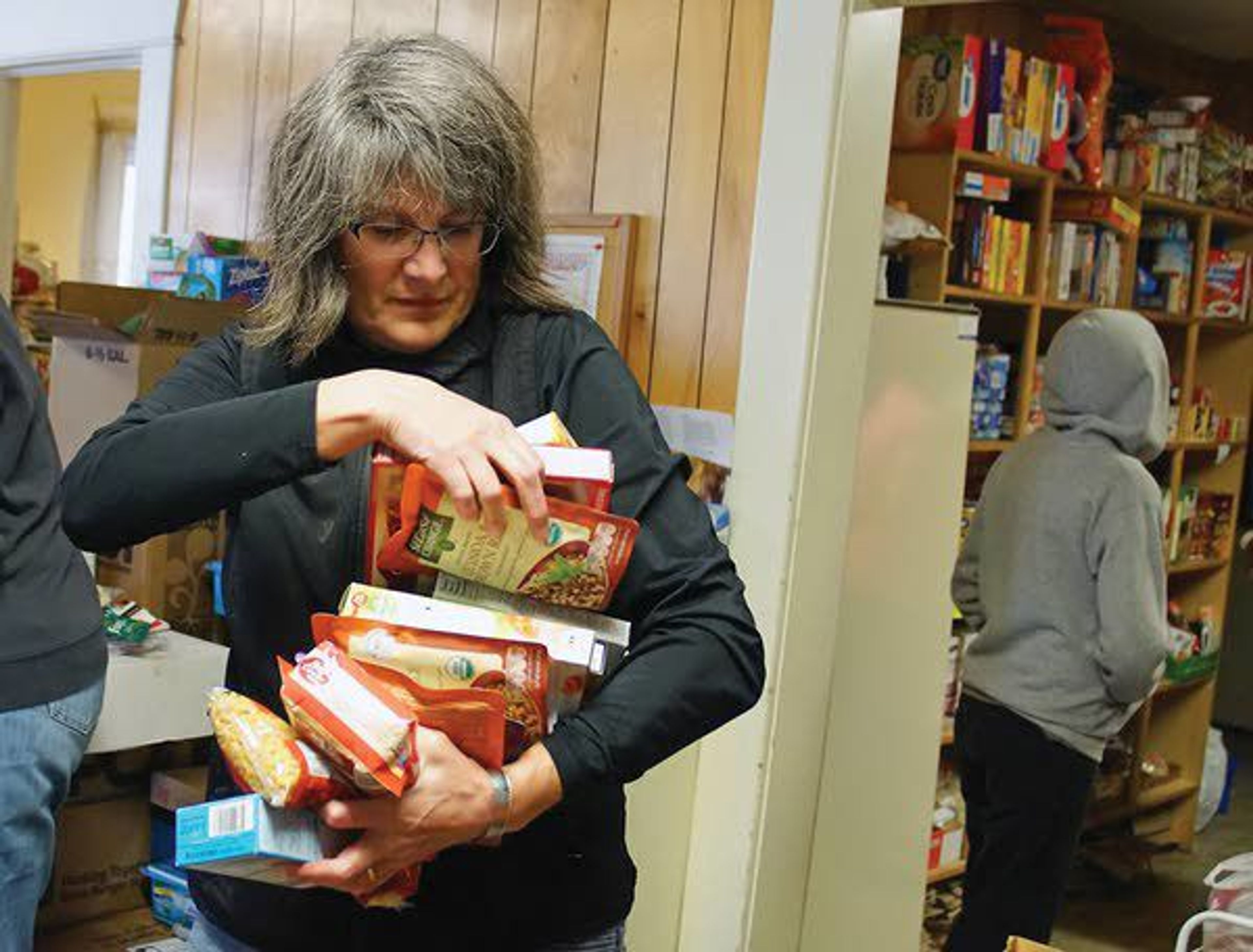 Karen Marsh sorts food at the Moscow Food Bank on Saturday during the 13th annual Palouse Cares Food Drive and Auctions.