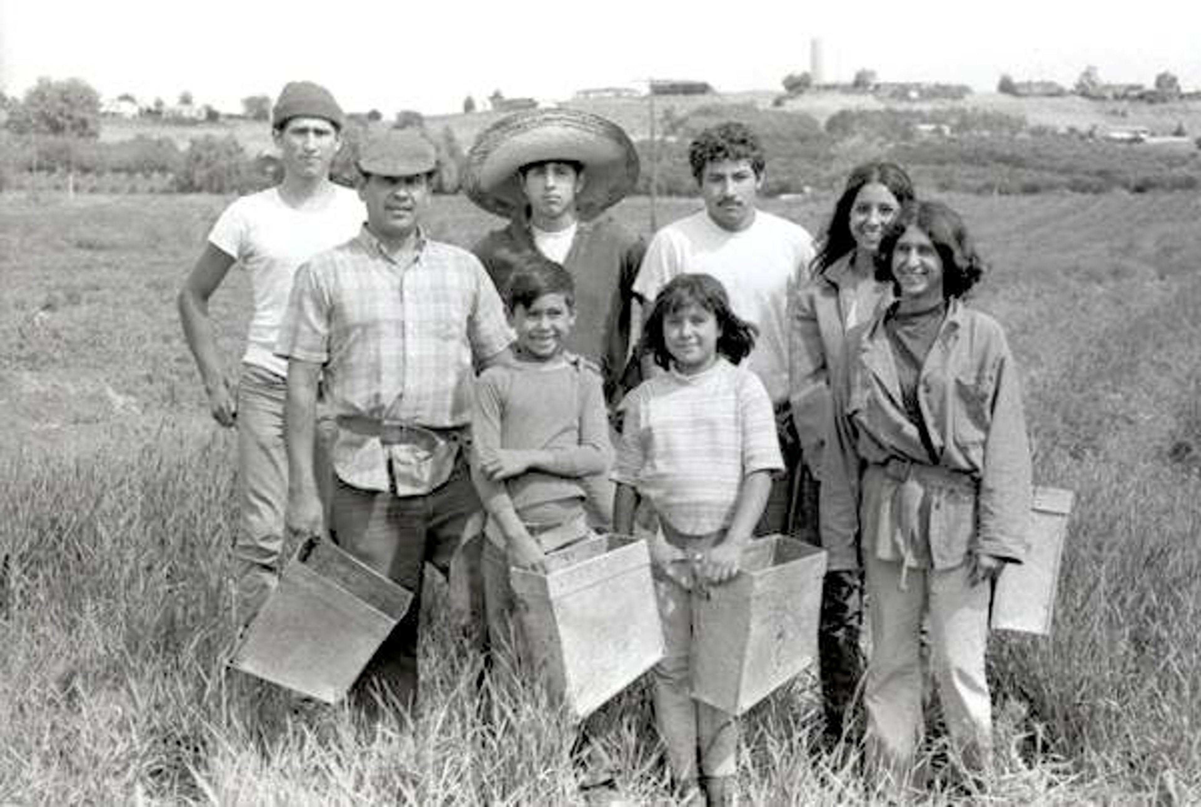 The Garcia family gathers with friends in an asparagus field in the Yakima Valley in 1968. The image is among thousands taken by Seattle photographer Irwin Nash of migrant agricultural workers in the valley in the 1960s and 1970s.