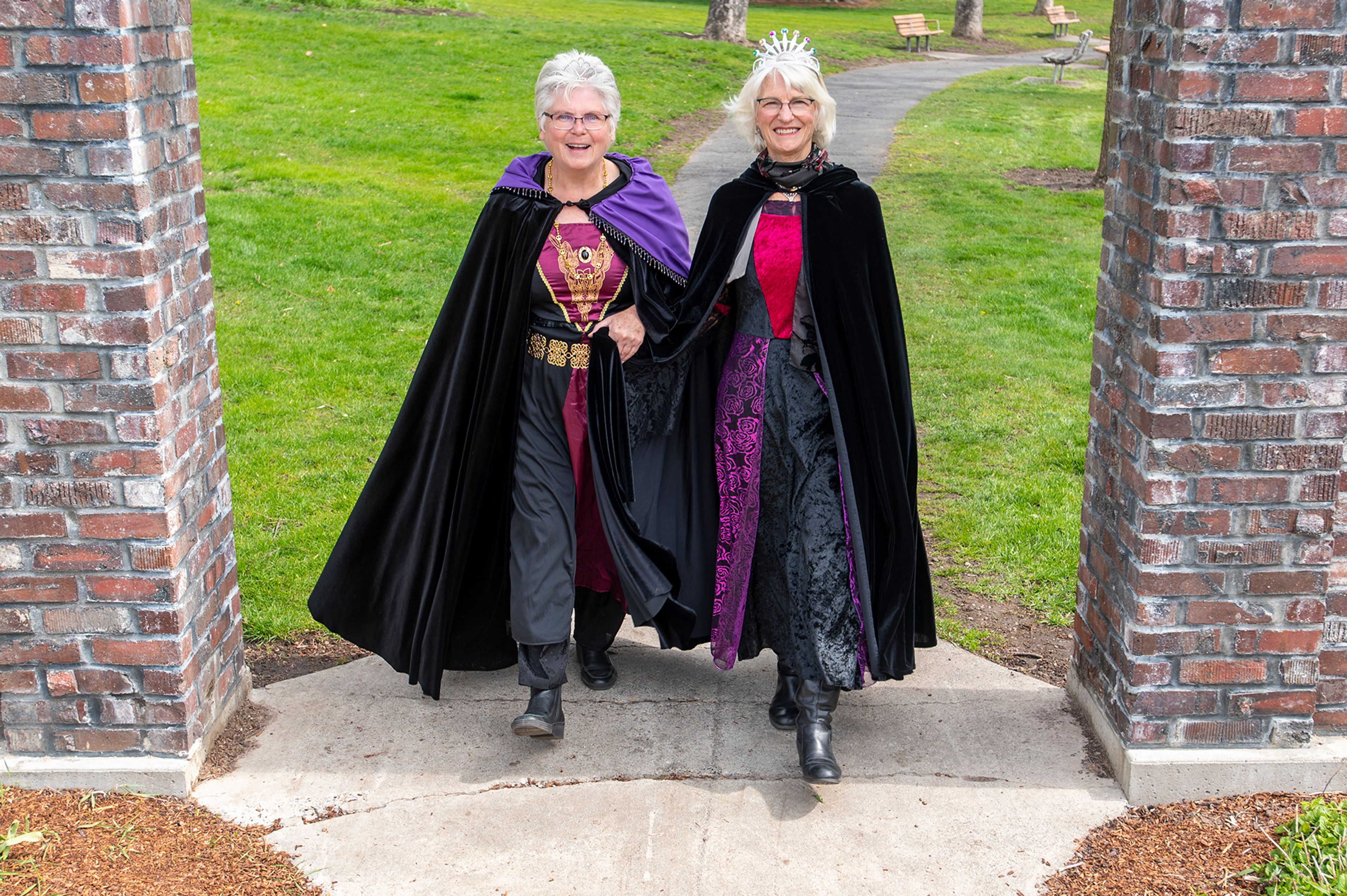 Zach Wilkinson/Daily News Rebecca Rod, left, and Theresa Beaver walk underneath the archway at East City Park on Thursday while dressed in their royal attire as queens of this weekend’s Renaissance Fair in Moscow. “It’s just a huge honor and we’re thrilled to represent Moscow. It’s been our community for all our married life,” Rod said.