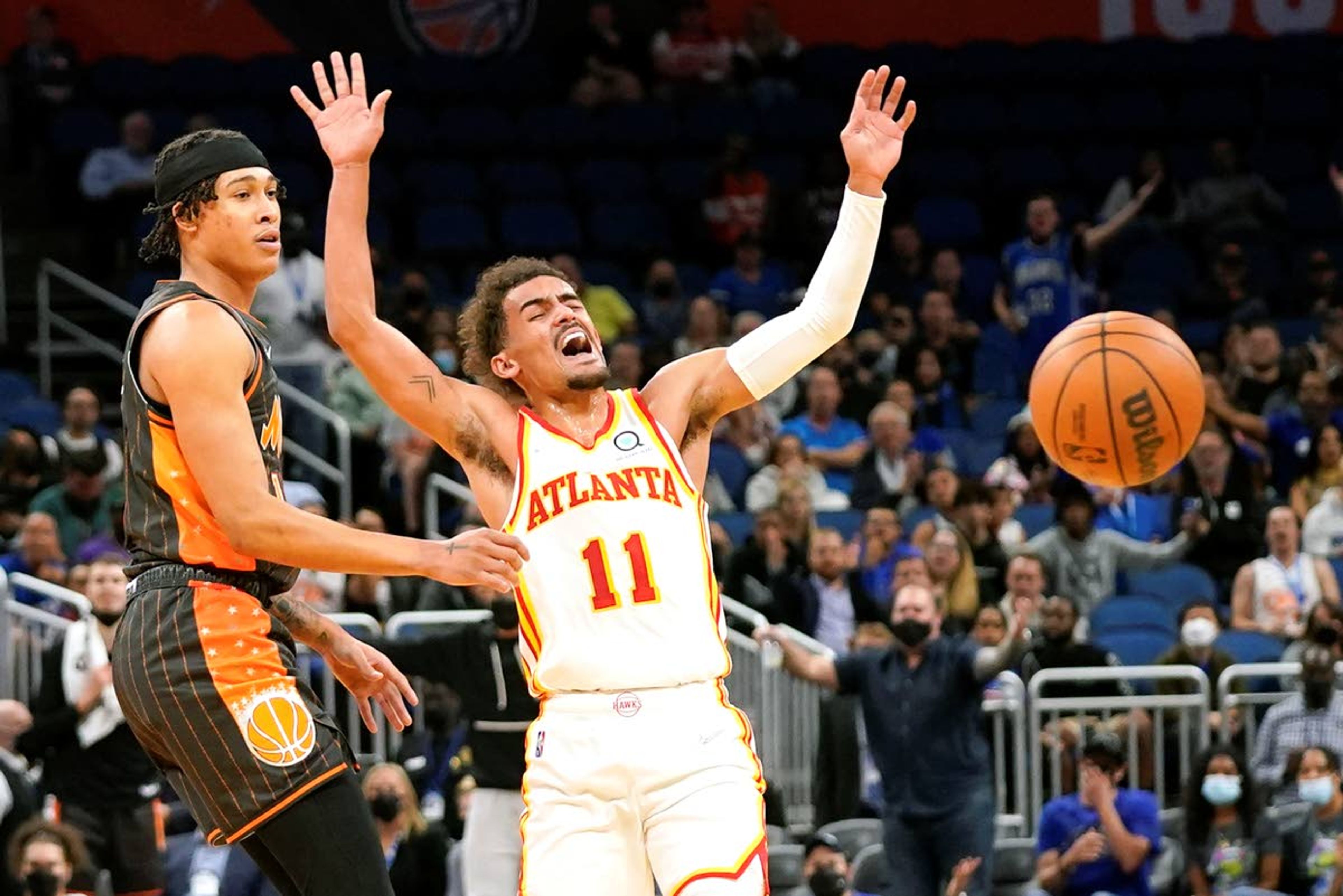 Atlanta Hawks guard Trae Young (11) reacts as Orlando Magic guard R.J. Hampton, left, knocks the ball from his hands during the first half of an NBA basketball game, Wednesday, Dec. 15, 2021, in Orlando, Fla. (AP Photo/John Raoux)