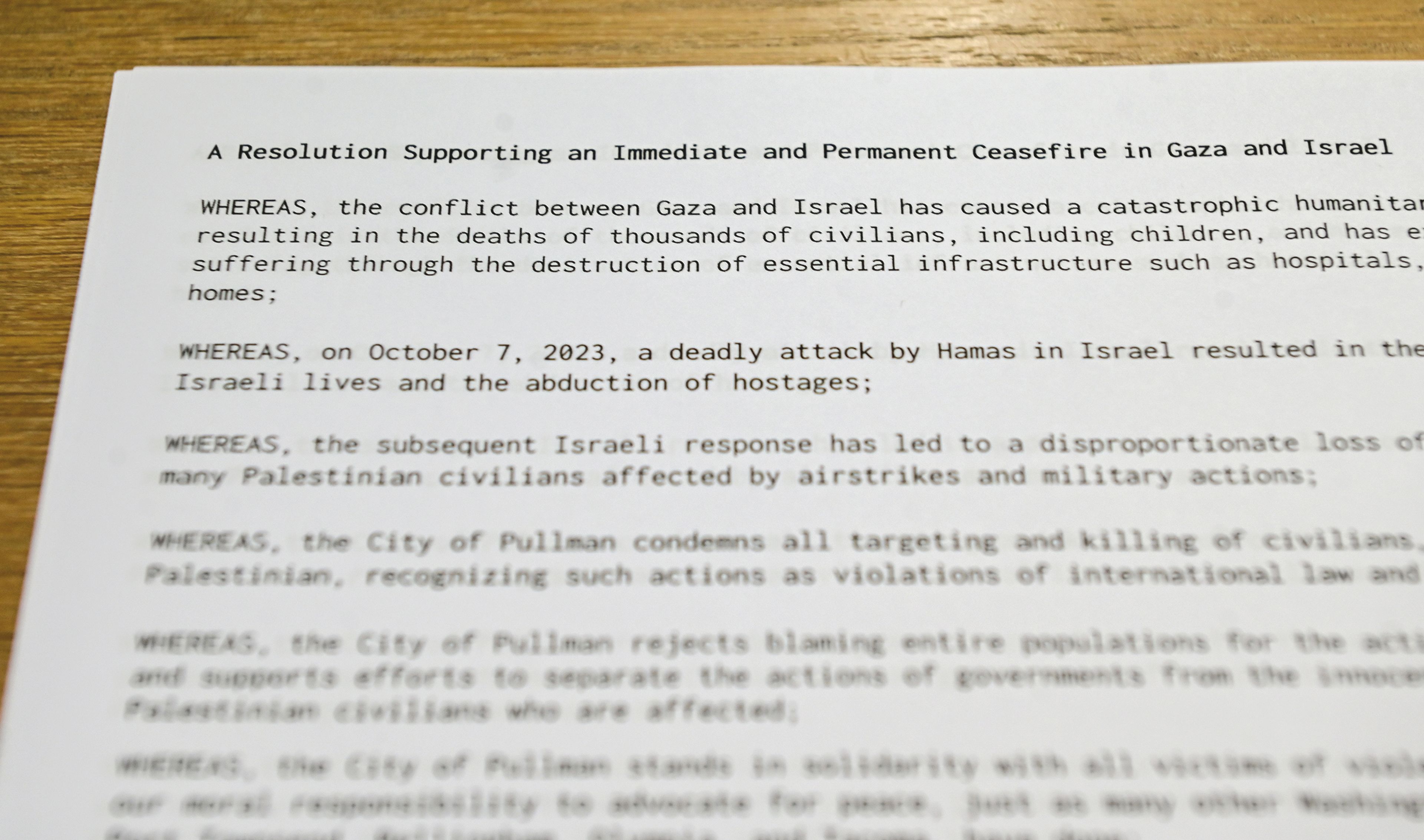 Copies of a drafted ceasefire resolution for Gaza and Israel sit out for those taking part in a listening session for input on the draft Monday at the Neill Public Library in Pullman.