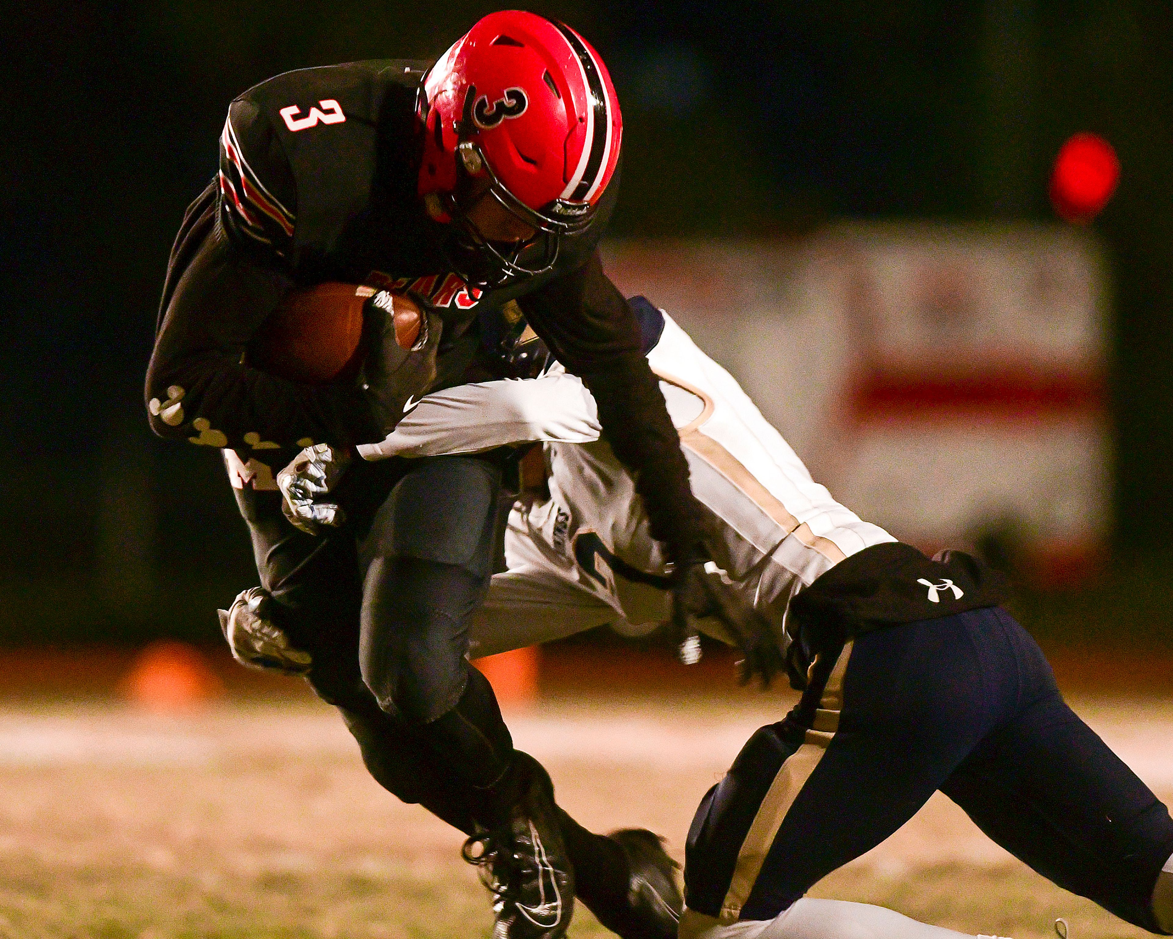 After catching a pass from quarterback Lane Hanson, Moscow receiver Jonah Elliss attempts to break away from a tackle by Middleton's Merit Foote during the third quarter of an Idaho Class 4A state playoff first-round game in 2019 in Moscow.