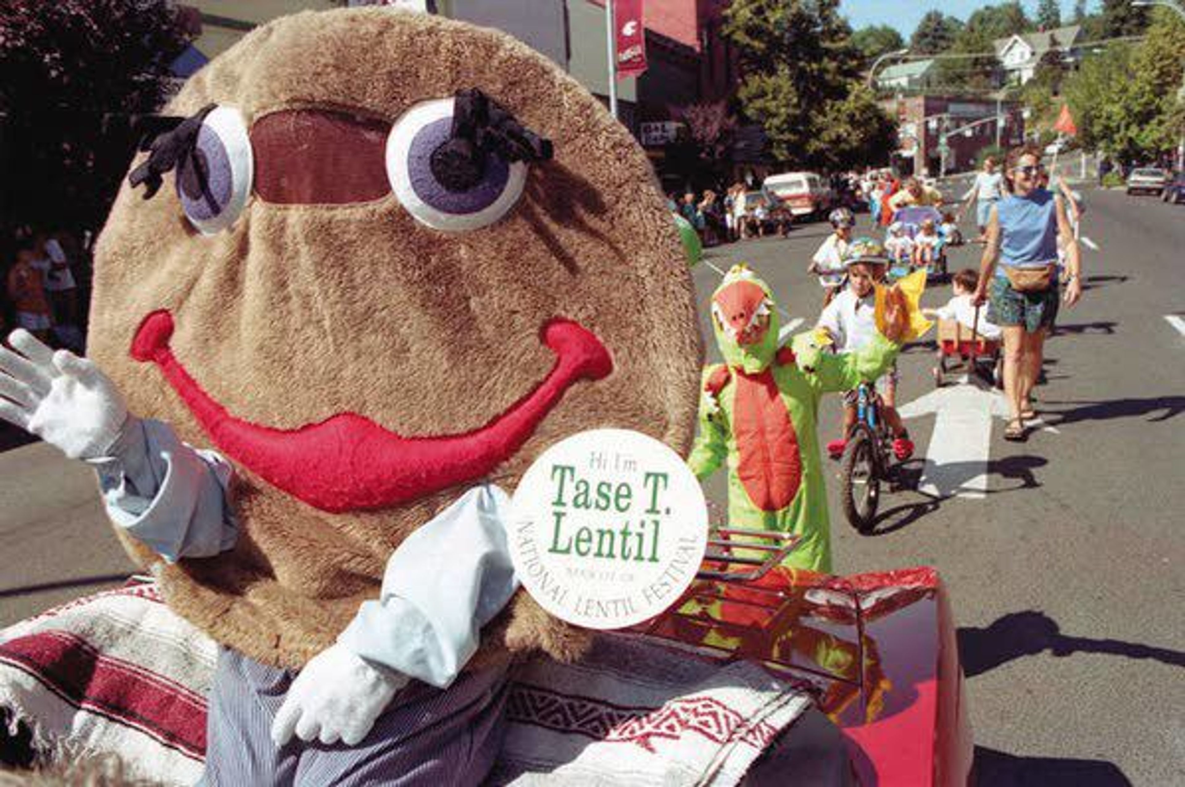 Above: Tase T. Lentil rides in the National Lentil Festival parade in downtown Pullman in 1997. Below: A woman participates in the 1992 National Lentil Festival Parade in downtown Pullman. The 30th annual event will be held this weekend.