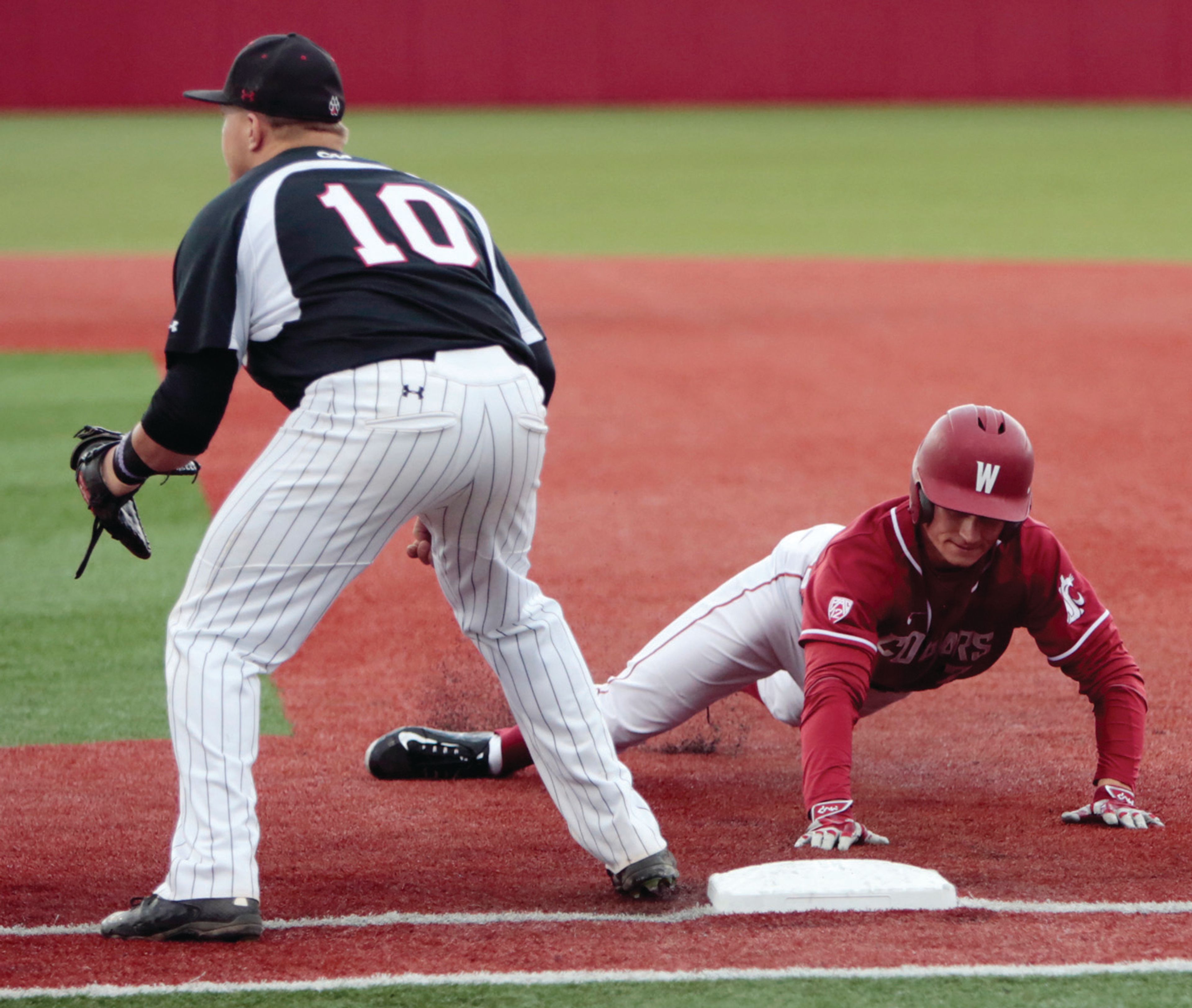 Washington State's Mason Cerrillo reaches for first base during the second inning March 10 against Northeastern.