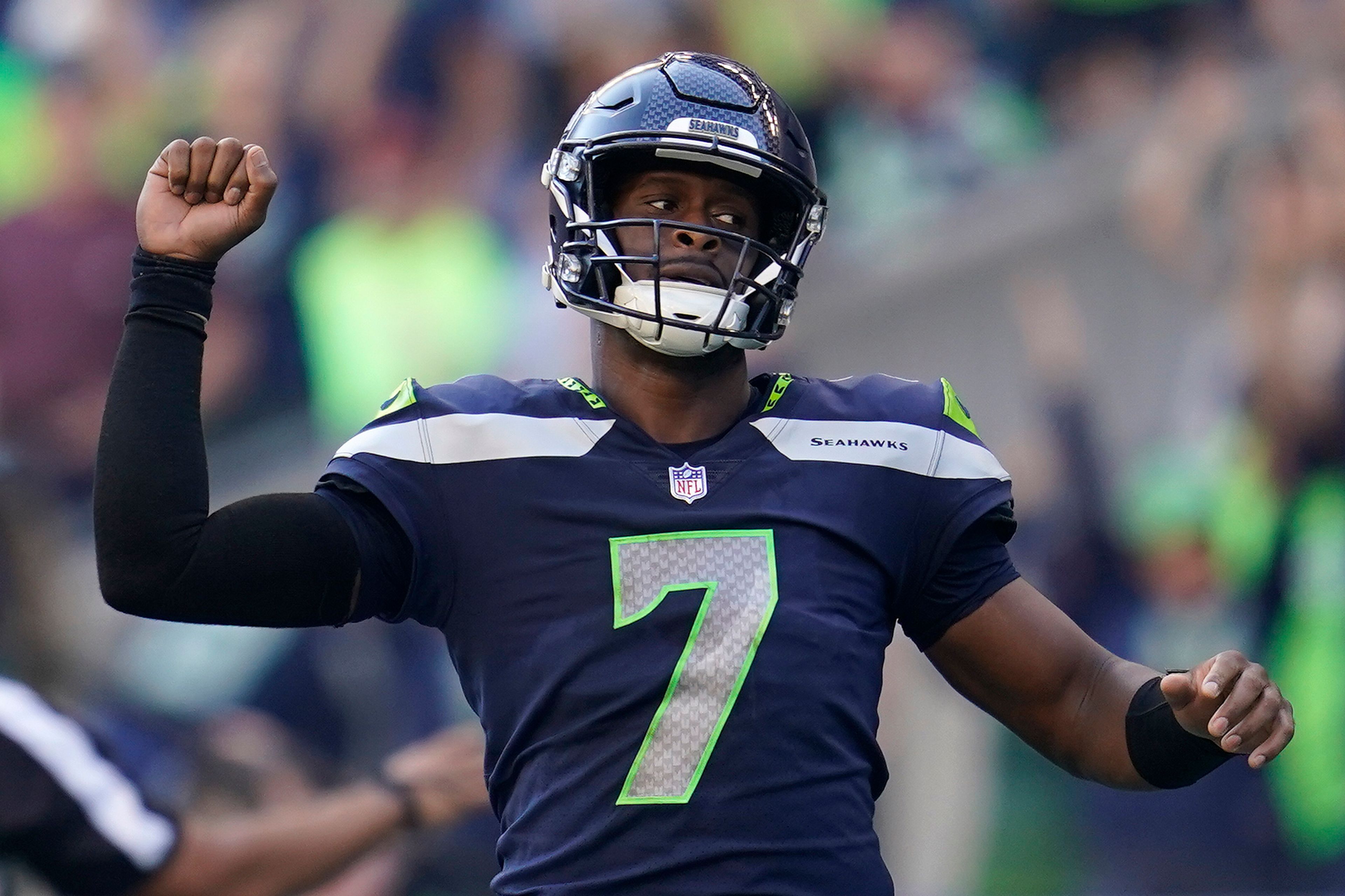 FILE - Seattle Seahawks quarterback Geno Smith (7) celebrates after a touchdown run by running back Kenneth Walker III during the second half of an NFL football game against the Arizona Cardinals in Seattle, Sunday, Oct. 16, 2022. Geno Smith finally got to enjoy a day of being in the spotlight after signing the big contract that had eluded most of his career. Smith's three-year contract with the Seahawks will keep him as the presumptive starting quarterback in Seattle following a breakout season. (AP Photo/Abbie Parr, File)